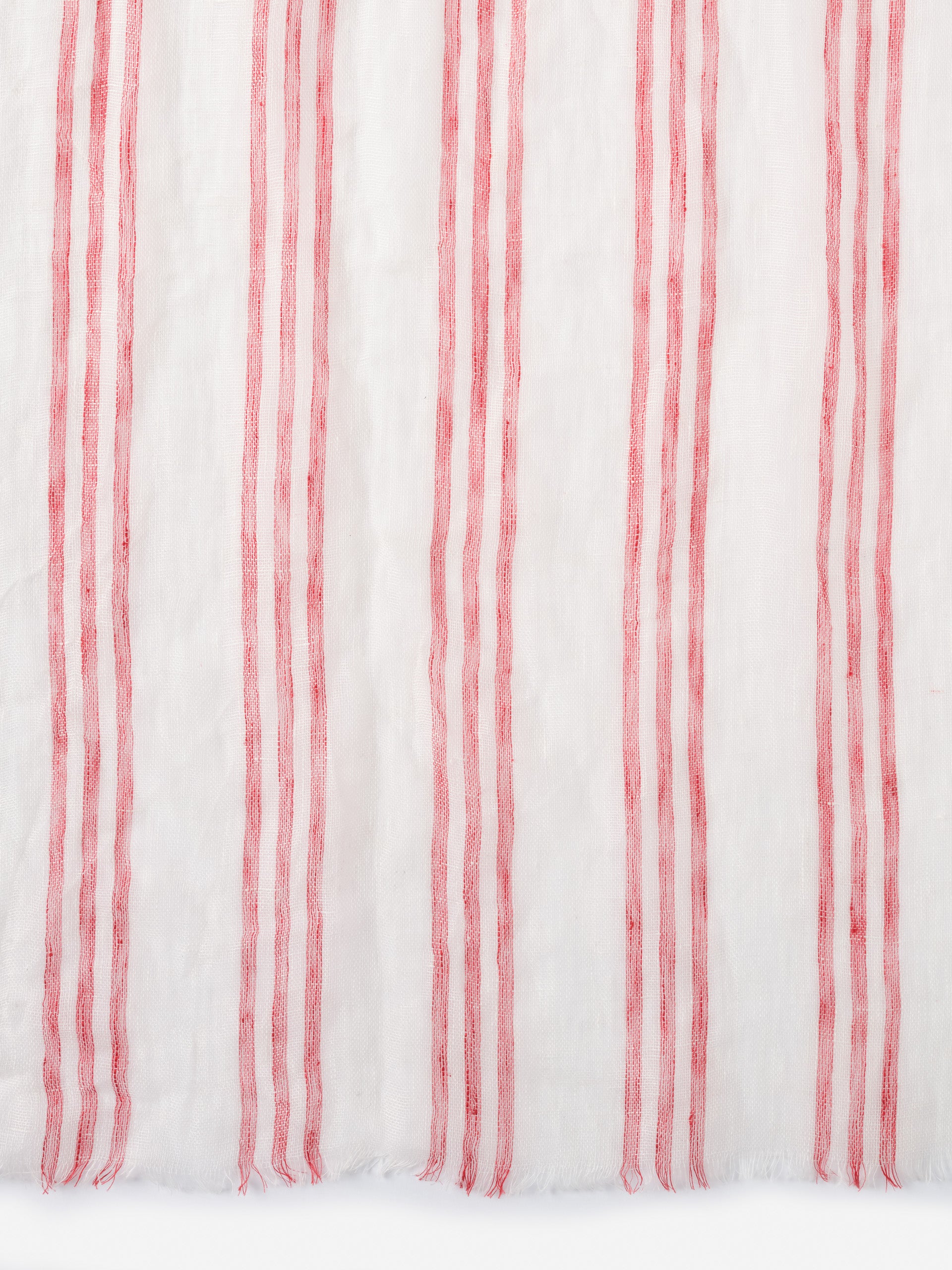 Close-up of the Tessa Linen Scarf in Stripe by J.McLaughlin featuring lightweight linen fabric with vertical red stripes, embodying effortlessly stylish, enduring designs and innovative fabrics.