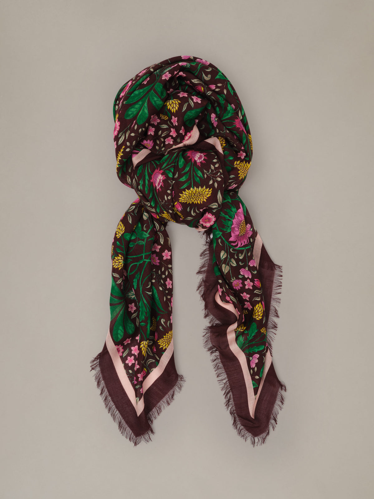 The Katherine Scarf in Mega Manor Floral Border soft modal wool scarf with a dark floral print draped in an elegant loop with fringed edges