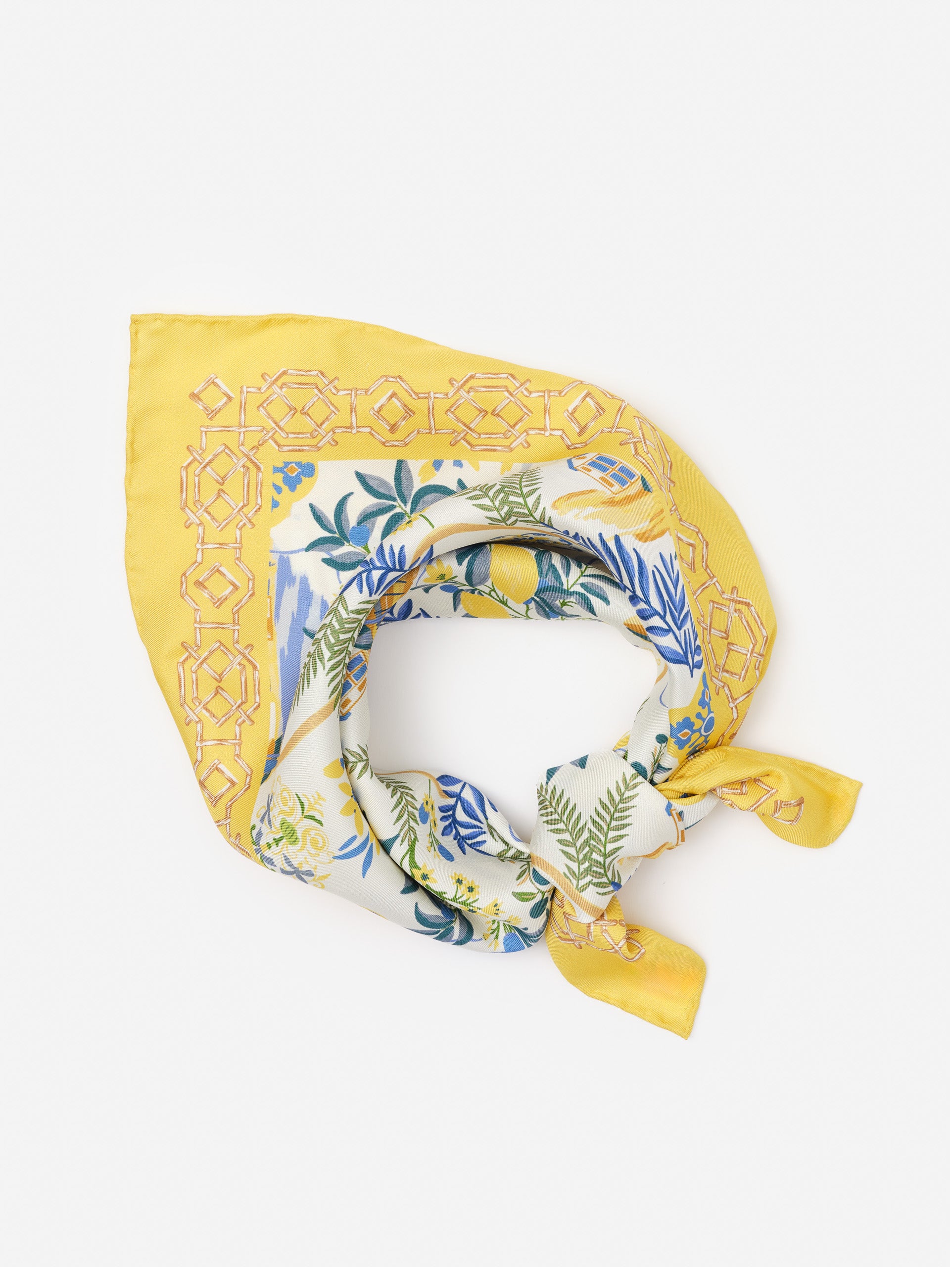 Nikka Silk Scarf in Amalfi Coast Bamboo by J.McLaughlin featuring effortlessly stylish yellow and blue botanical patterns on innovative silk fabric, embodying enduring designs and a legacy of timeless fashion. A destination for defining style. Life, Well-Lived.