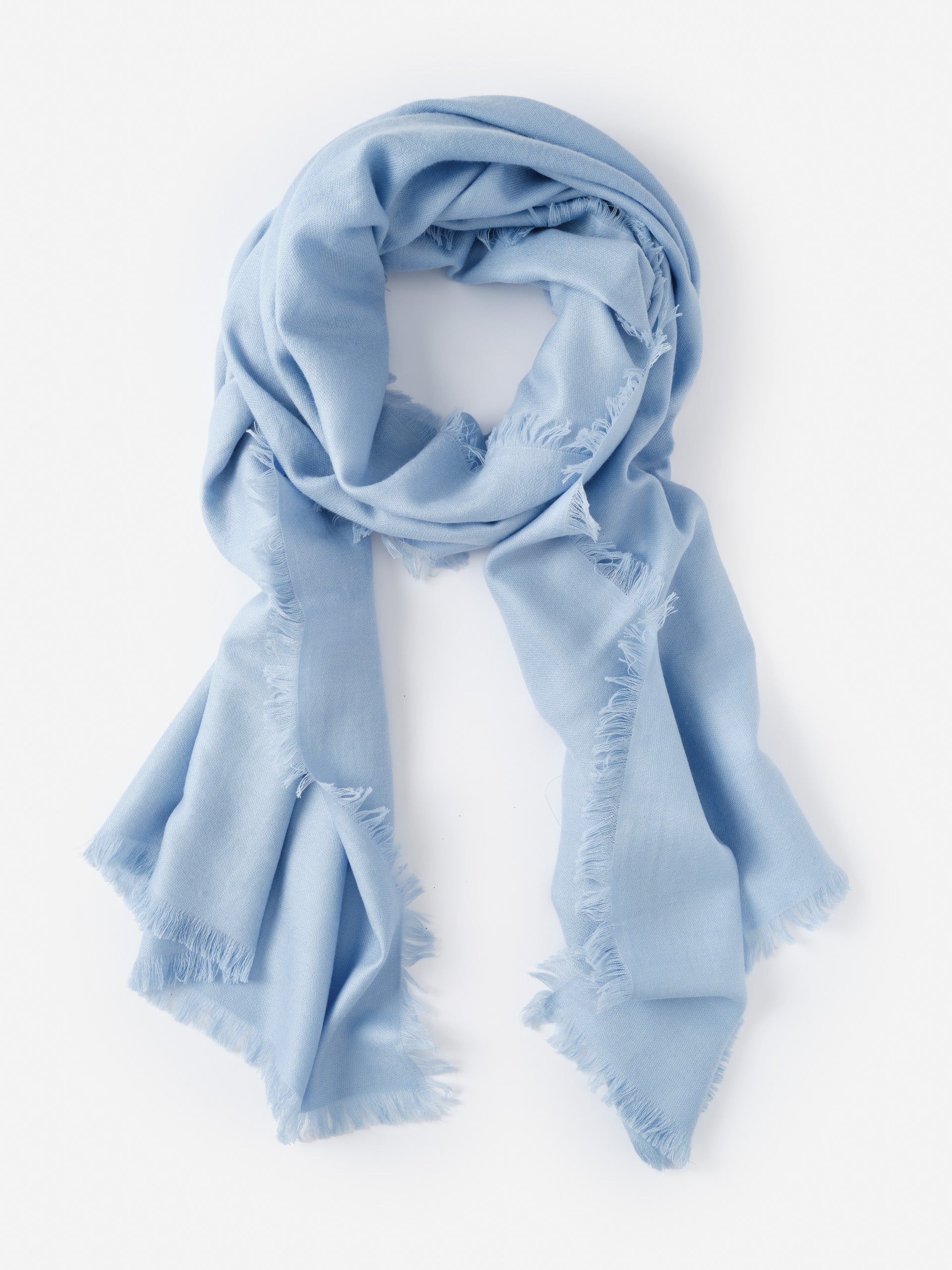 Soft light blue Carey Cashmere Scarf by J.McLaughlin featuring delicate fringed edges, embodying effortlessly stylish and enduring designs for a life well-lived.