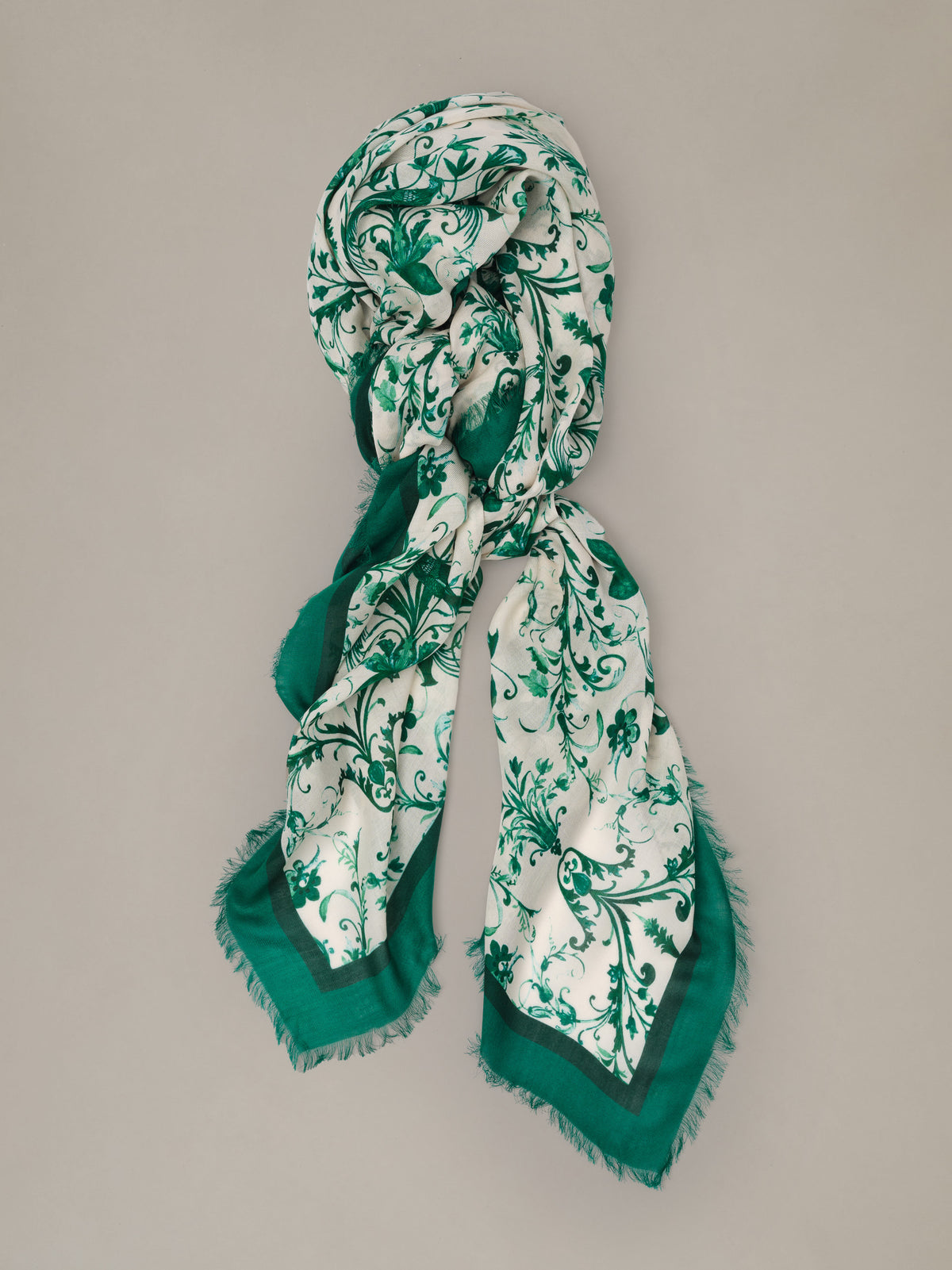 The Katherine Scarf in Garden Flight Border by J.McLaughlin featuring an elegant green and ivory botanical bird print with fringed edges draped gracefully around the neck