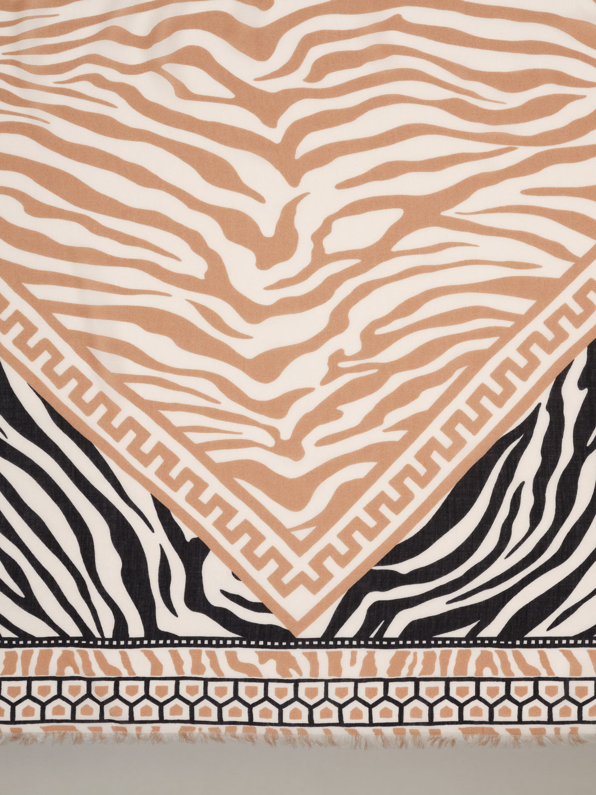 The Katherine Scarf in Wild Medley Border by J.McLaughlin featuring tan and black zebra stripes with a geometric border in a timeless scarf design