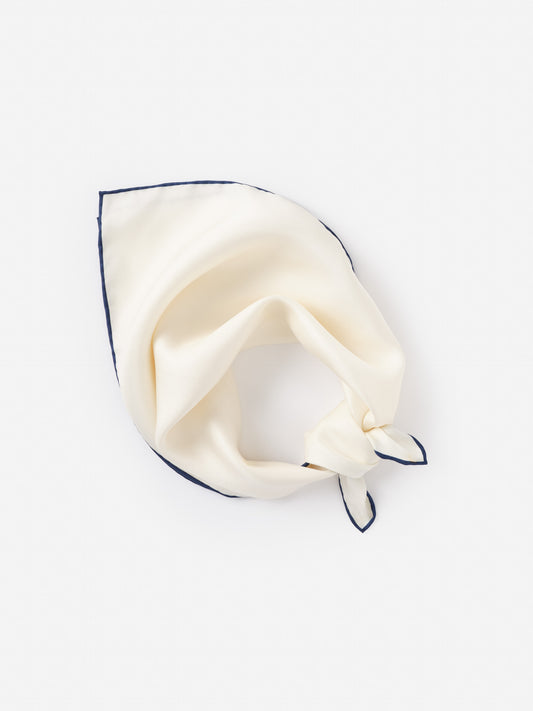 Cream-colored Xani Silk Scarf by J.McLaughlin with a delicate navy trim, showcasing effortlessly stylish and enduring design from a legacy of timeless fashion.