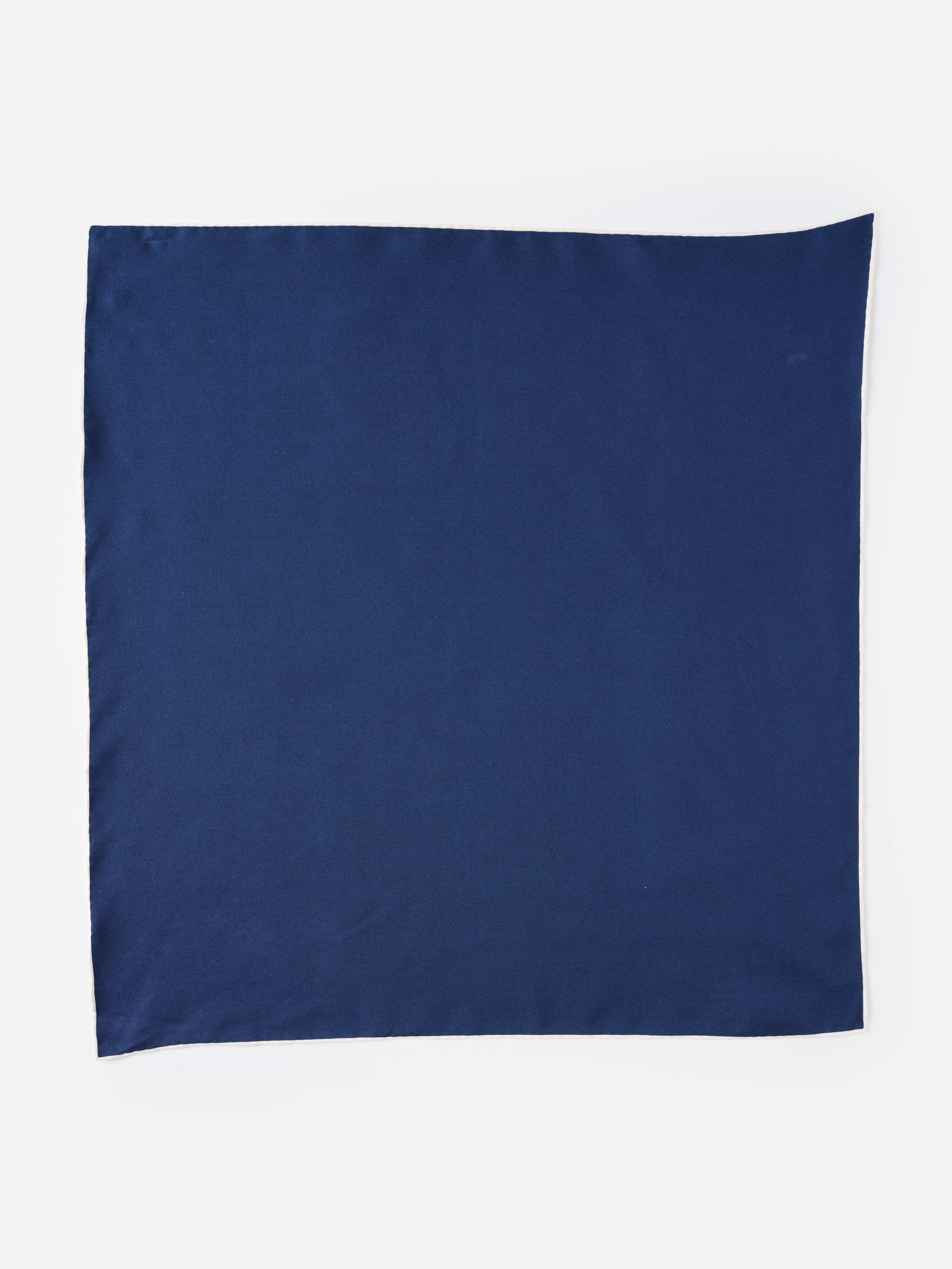 Smooth navy blue Xani Silk Scarf by J.McLaughlin, crafted with innovative fabrics for enduring designs that embody effortlessly stylish, timeless fashion.