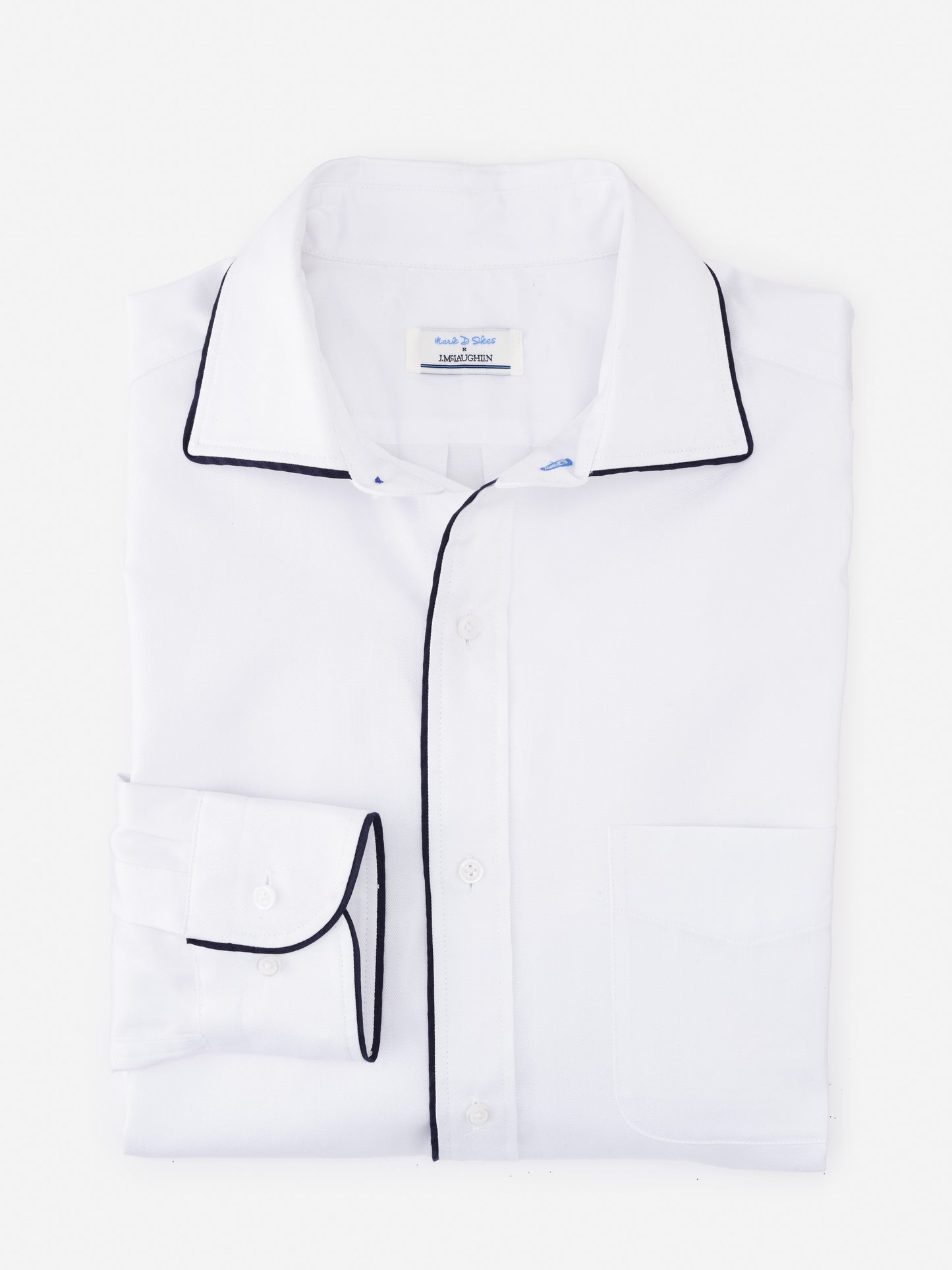 Folded white Anderson Cotton Shirt by J.McLaughlin with black piping details on collar, cuffs, and button placket, showcasing effortlessly stylish, enduring designs and innovative fabrics.