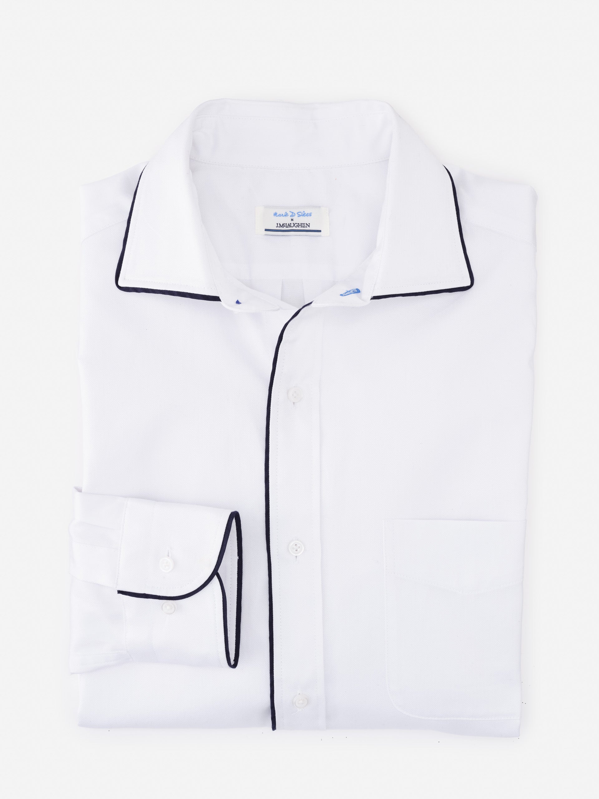 Folded white Anderson Cotton Shirt by J.McLaughlin with black piping details on collar, cuffs, and button placket, showcasing effortlessly stylish, enduring designs and innovative fabrics.