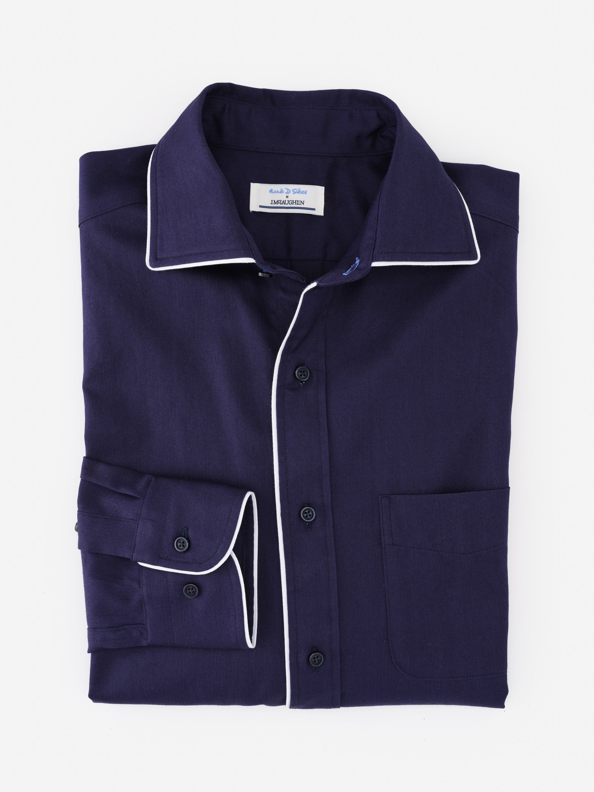 Folded Anderson Cotton Shirt by J.McLaughlin in deep navy with white piping accents on collar and cuffs, showcasing effortlessly stylish, enduring designs and innovative fabrics.