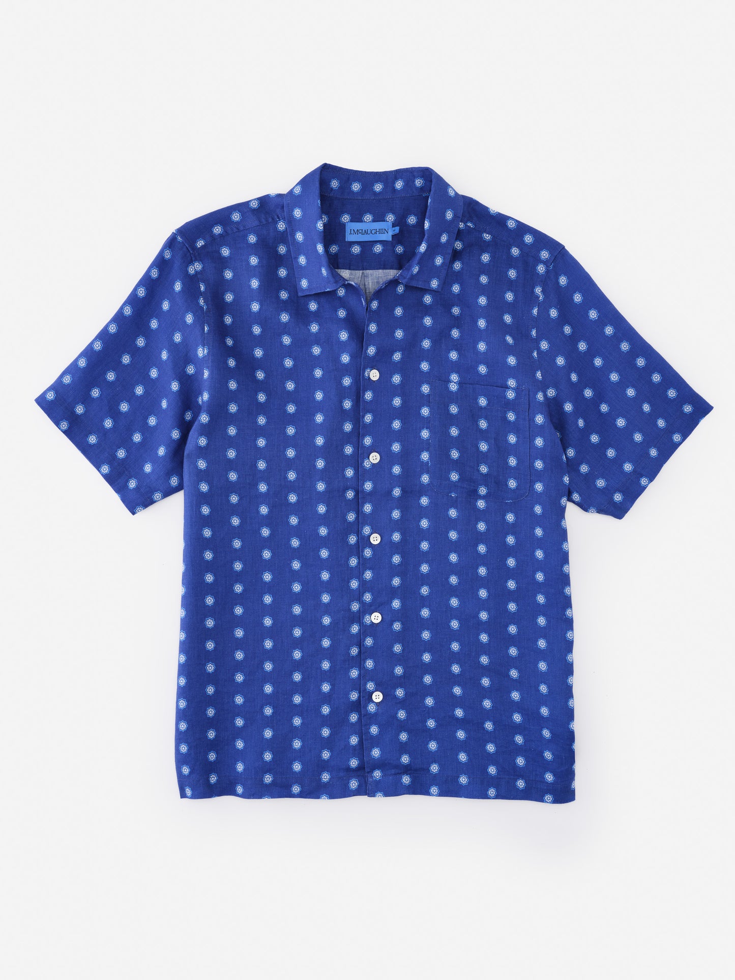 Montauk Linen Shirt in Castine Bandana Geo by J.McLaughlin features a classic short-sleeve design in an effortlessly stylish blue pattern, blending enduring designs with innovative fabrics. A destination for defining style. Life, Well-Lived.