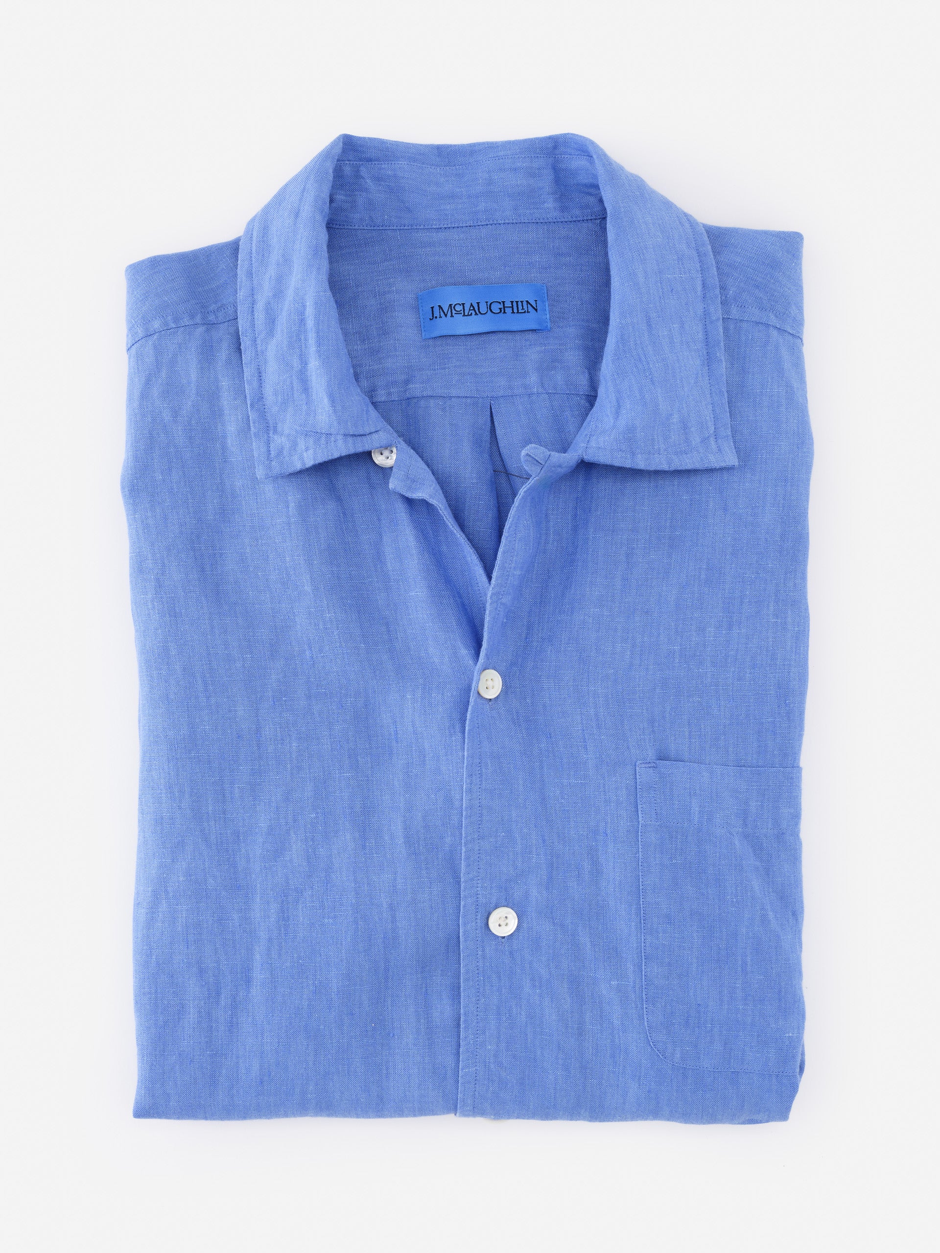 Folded Montauk Linen Shirt in soft blue by J.McLaughlin, showcasing effortlessly stylish design and innovative fabrics for enduring fashion. A destination for defining style. Life, Well-Lived.