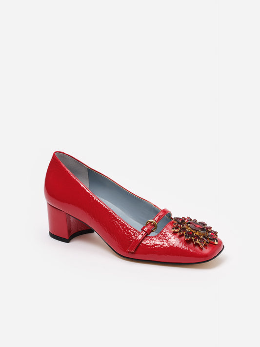 Red patent leather Jojo Leather Mary Jane Pumps by J.McLaughlin featuring a low block heel and embellished floral rosette buckle for a classic, stylish look.