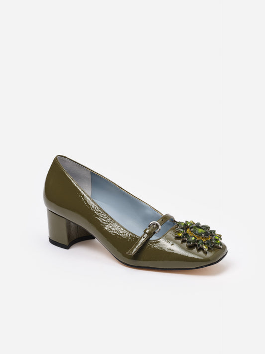 Olive green Jojo Leather Mary Jane Pumps by J.McLaughlin featuring a glossy finish, low block heel, square toe, and a floral rosette embellishment for elegant style.