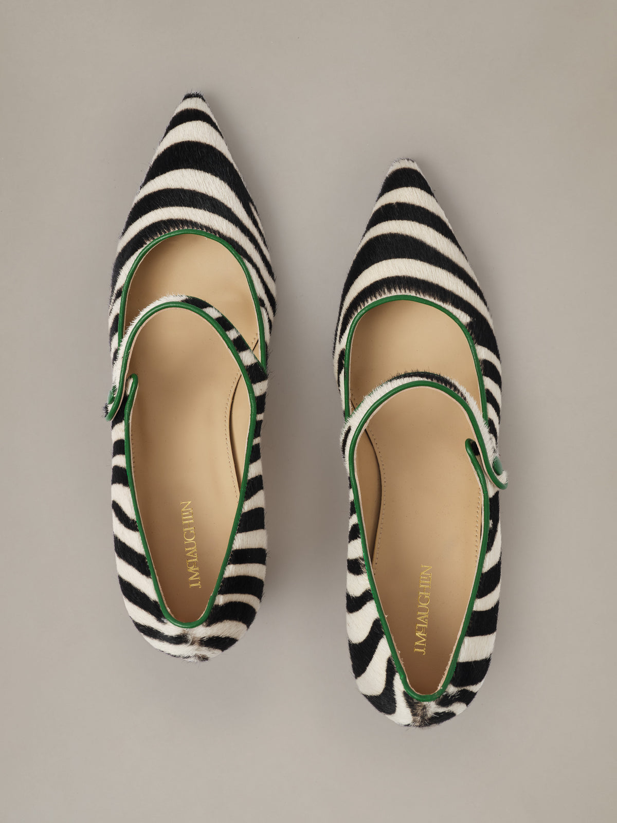 Katie Calf Hair Pumps in Zebra by J.McLaughlin featuring pointed toes and classic straps in bold zebra print with elegant two and three quarter inch heels