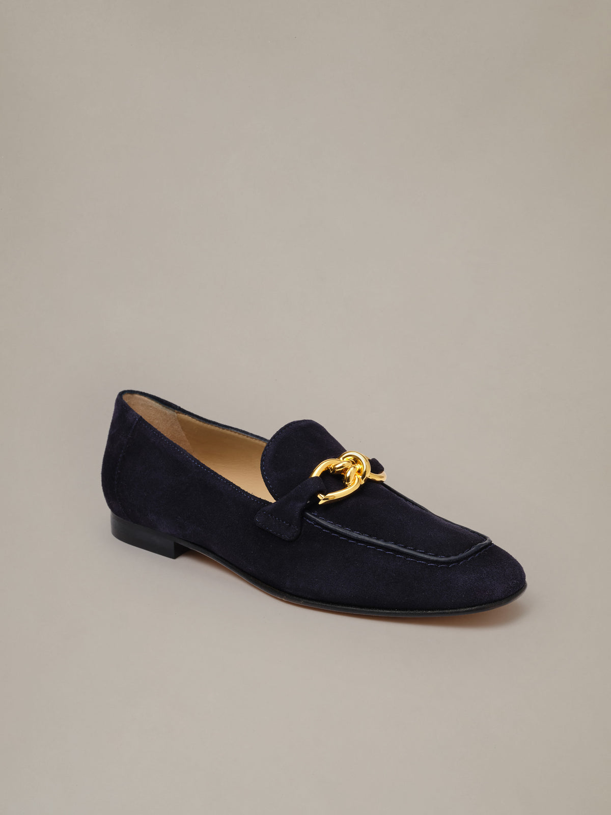 Mila Suede Loafers by J.McLaughlin in navy suede with a gold horsebit detail and low stacked heel shown in profile