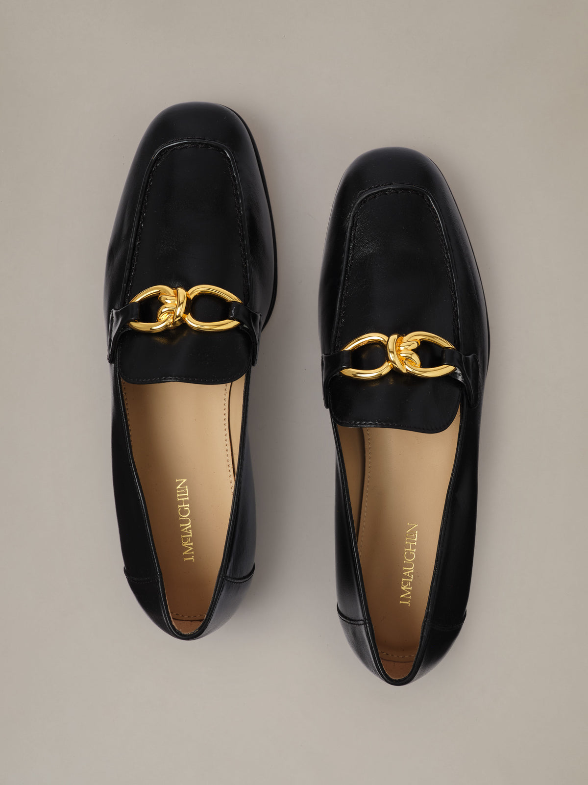 Mila Leather Loafers by J.McLaughlin in black leather with gold horsebit details shown from above on a neutral background
