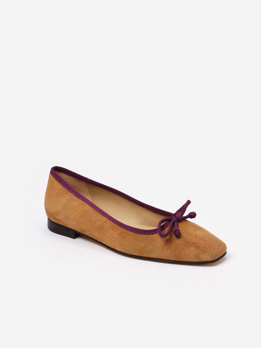 Viola Suede Ballet Flats in tan with purple trim and bow detail, showcasing J.McLaughlin’s commitment to timeless style and expert craftsmanship in elegant shoes.