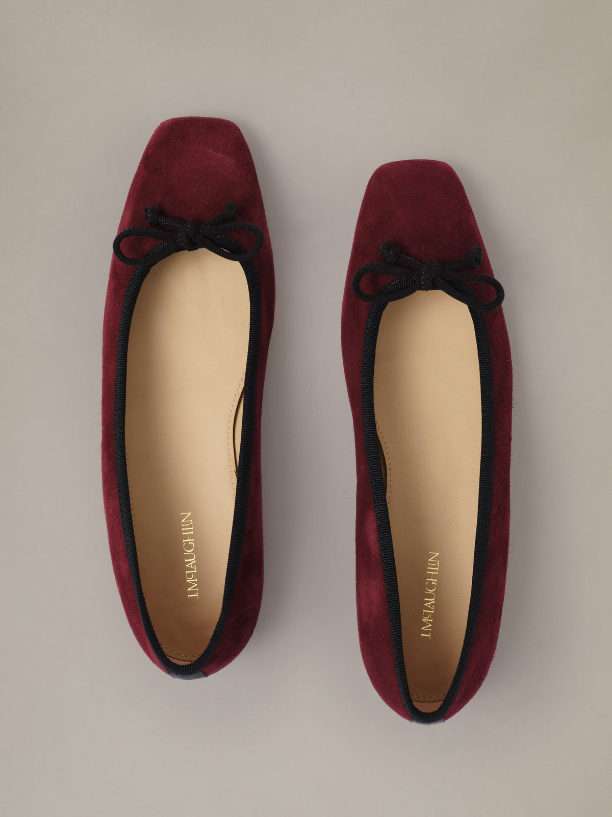 Viola Suede Ballet Flats by J.McLaughlin in burgundy suede with square toes and black bows shown from above