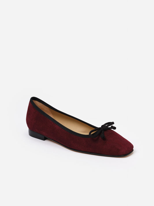 Viola Suede Ballet Flats by J.McLaughlin in rich burgundy with black trim and bow detail, showcasing classic craftsmanship and effortlessly stylish suede shoes for women.