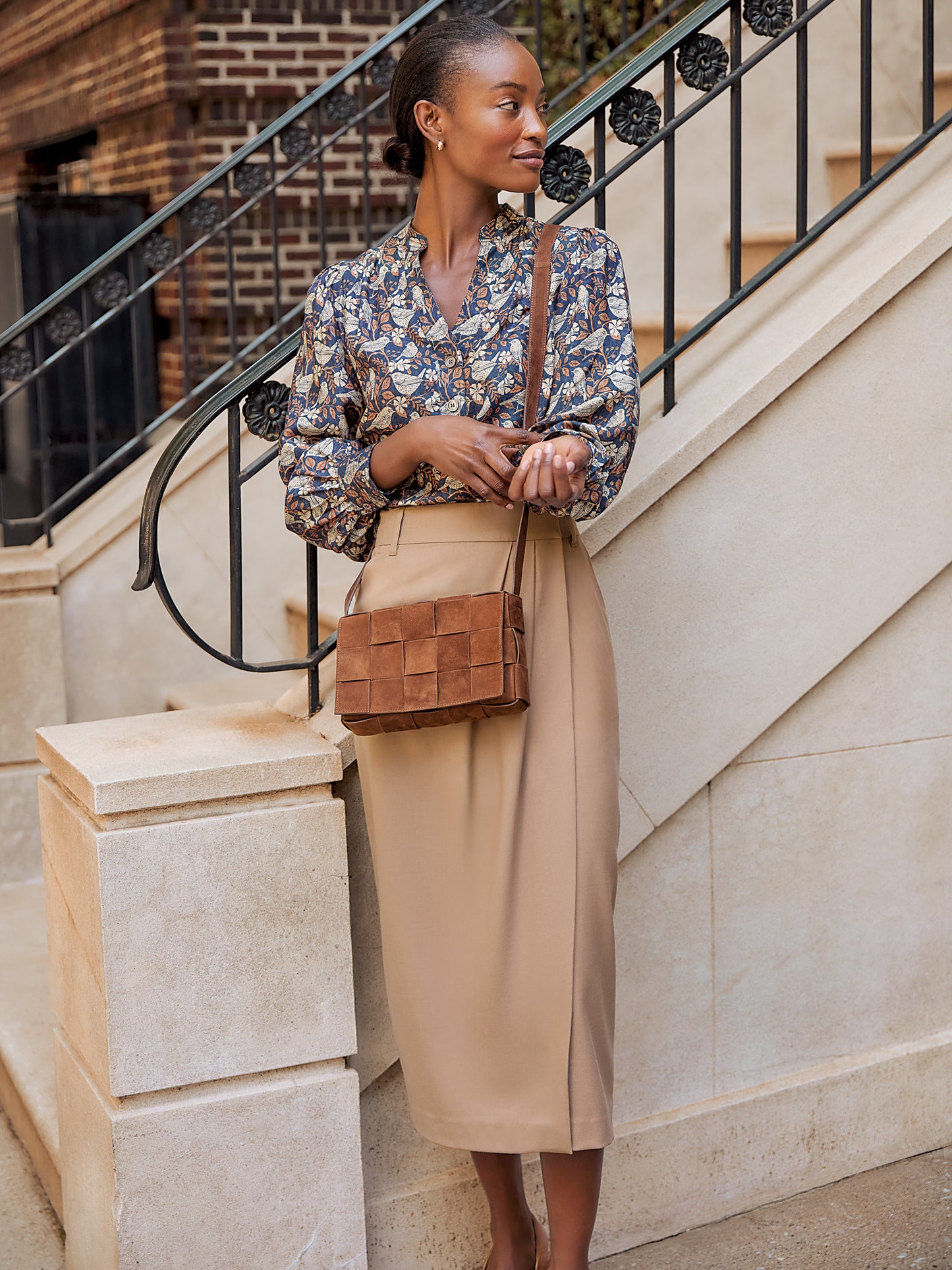 Model wearing J.McLaughlin Rashell blouse in charcoal/camel made with viscose/silk.