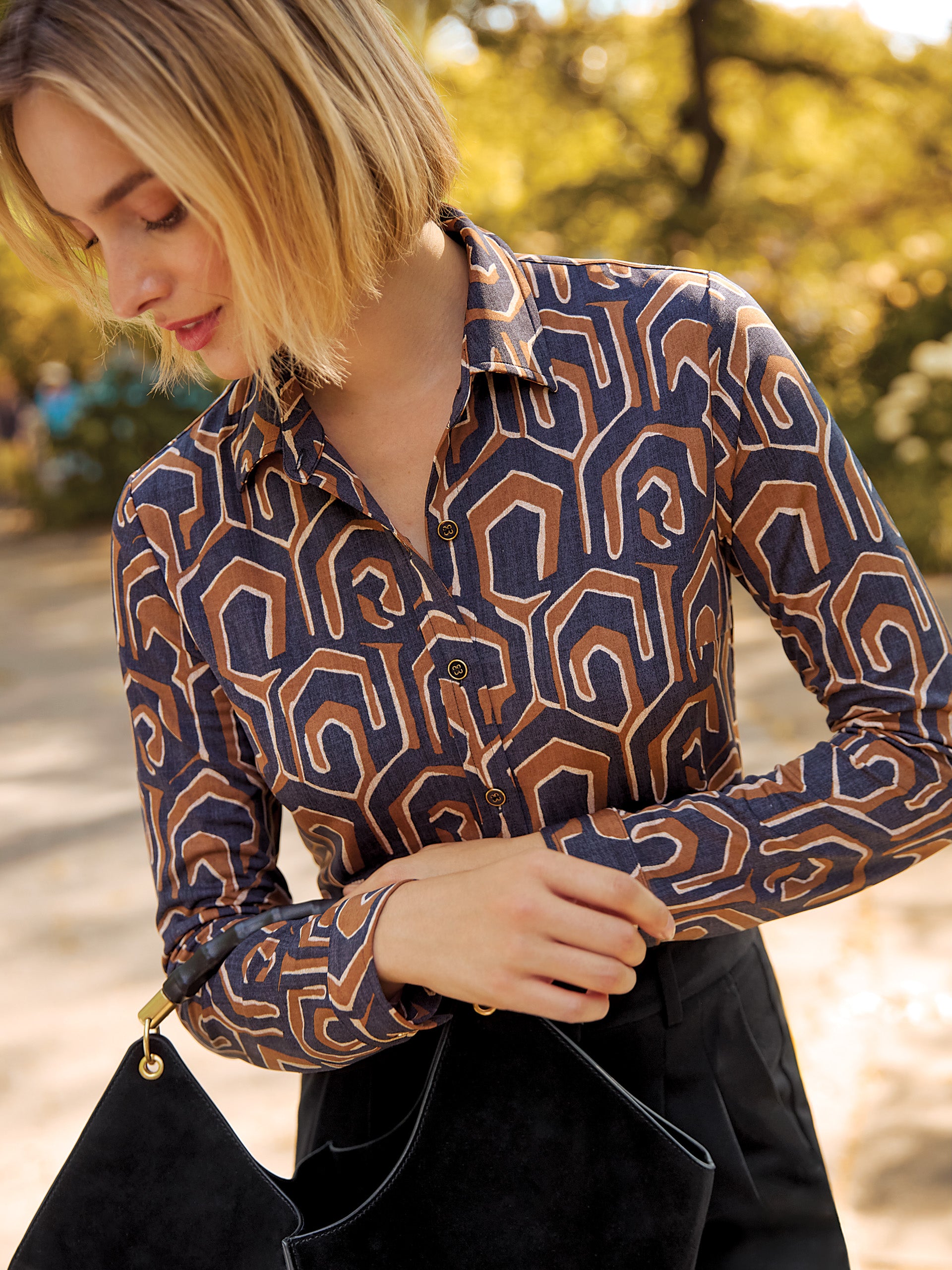 Model wearing J.McLaughlin Betty shirt in black/camel made with Catalina cloth.