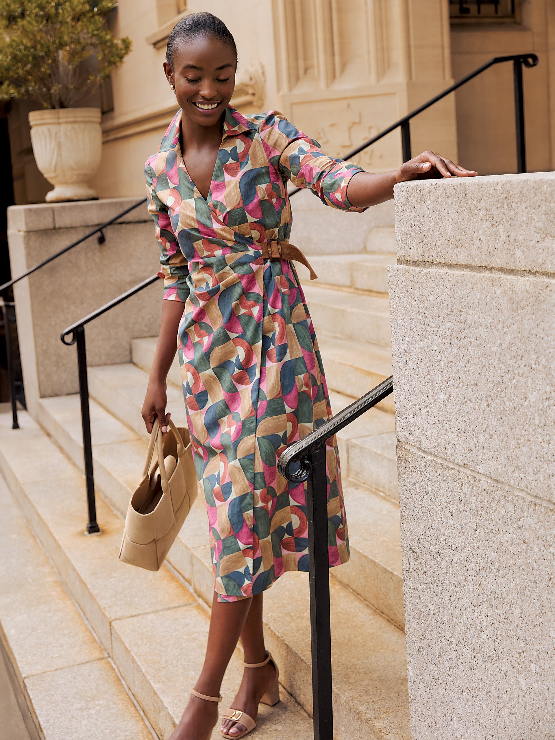 Model wearing J.McLaughlin Mercer dress in olive/multi made with cotton/spandex.