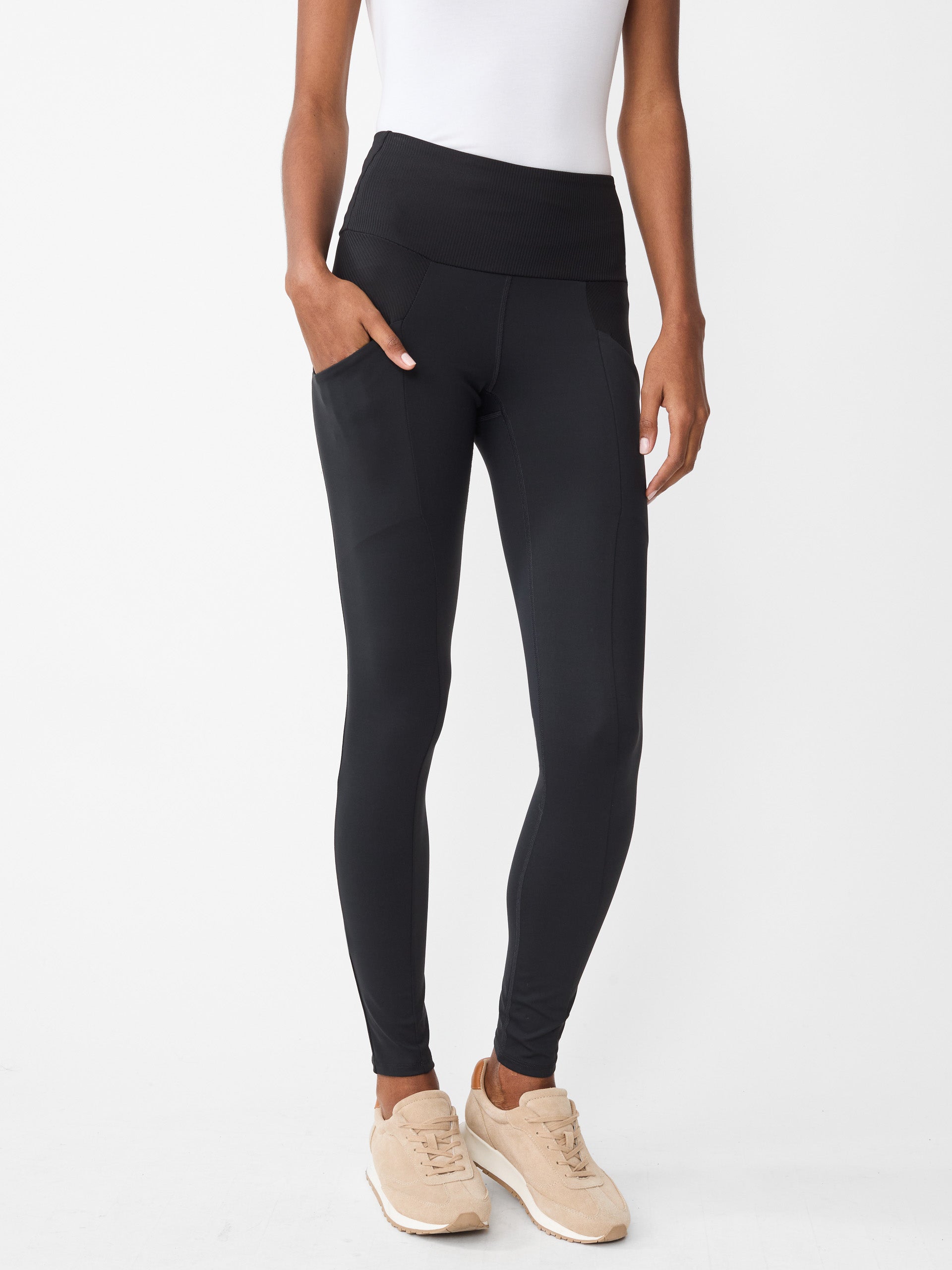 Model wearing J.McLaughlin Agon leggings in black made with Acadia fabric.