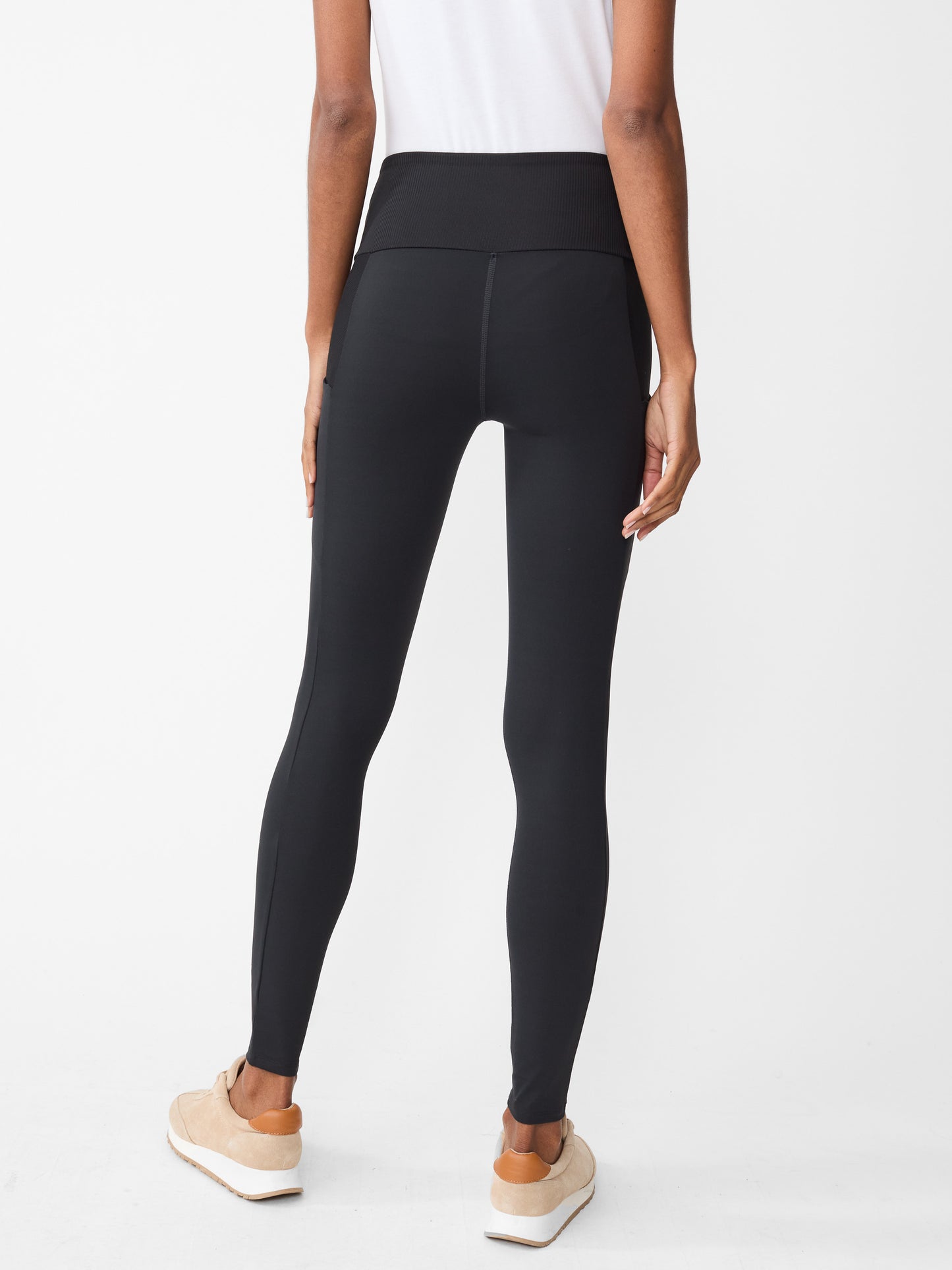 Model wearing J.McLaughlin Agon leggings in black made with Acadia fabric.