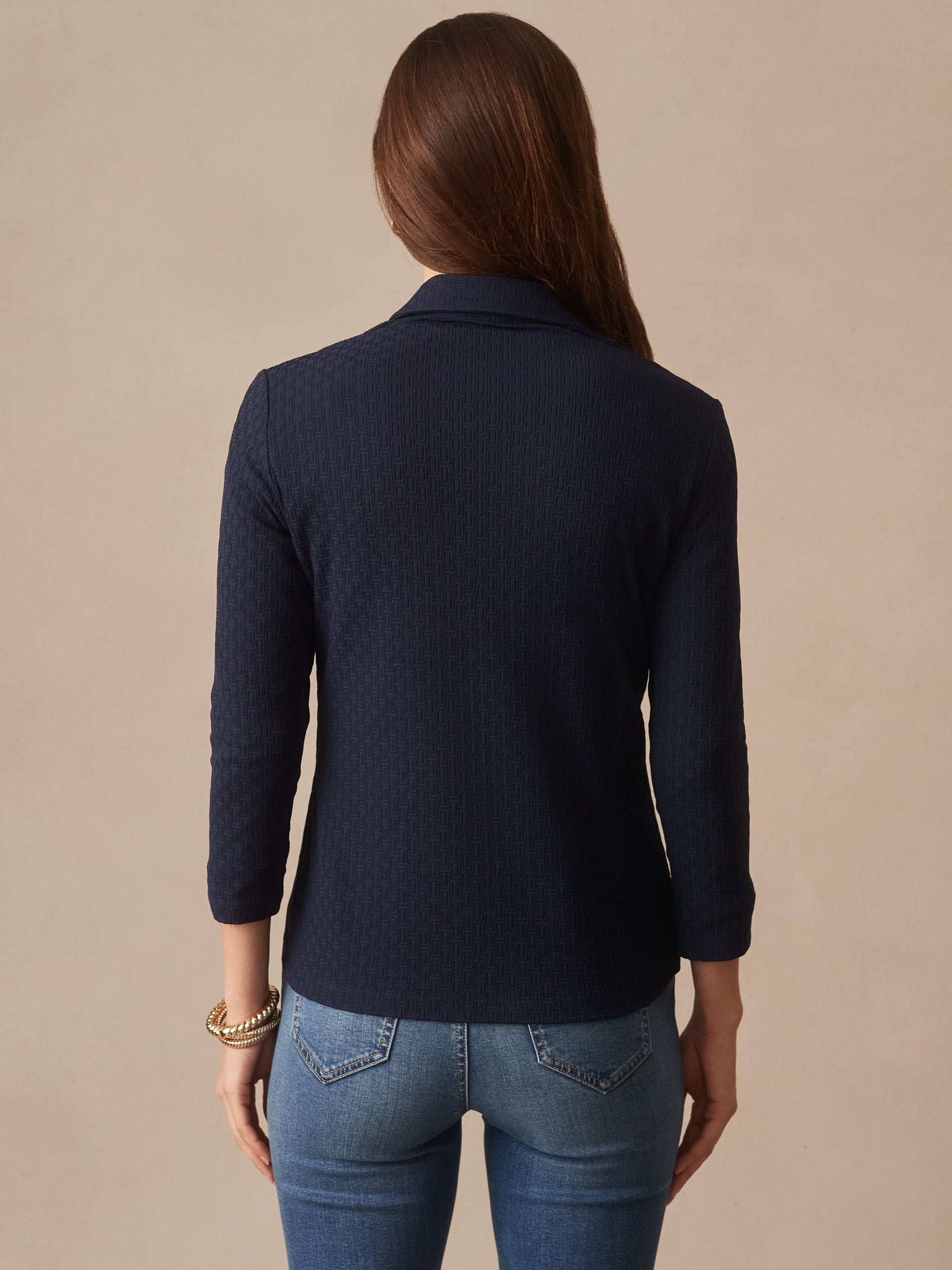 Woman wearing a navy Aida 3/4 Sleeve Top in Dashing Jacquard by J.McLaughlin, featuring innovative fabrics and enduring designs for effortlessly stylish, timeless fashion.