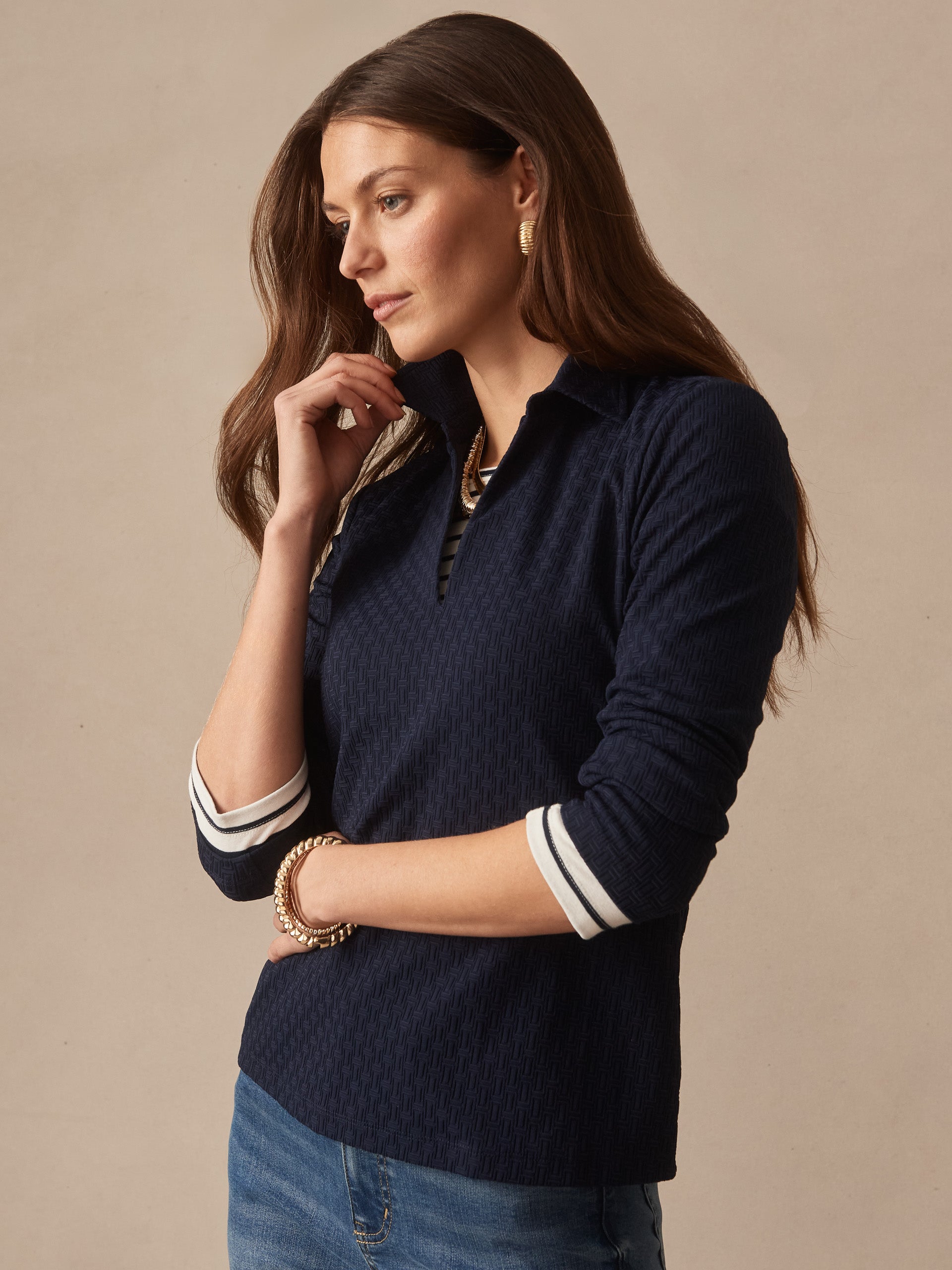 Woman wearing the Aida 3/4 Sleeve Top in Dashing Jacquard by J.McLaughlin, showcasing effortlessly stylish design and innovative fabric in a timeless navy blue pattern.