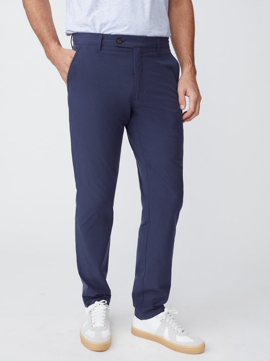 Model wearing J.McLaughlin Akin pants in navy made with Performance fabric.