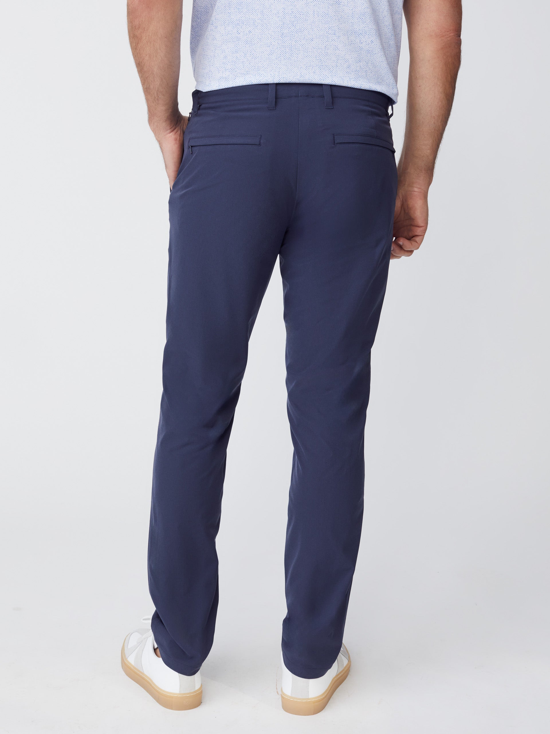 Model wearing J.McLaughlin Akin pants in navy made with Performance fabric.