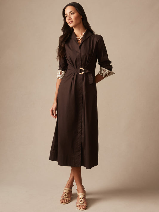 Woman wearing a chocolate brown Alina Dress by J.McLaughlin featuring a belted waist and patterned cuffs, showcasing effortlessly stylish and enduring designs in timeless fashion.