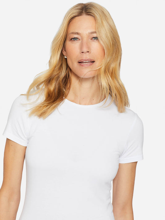 Model wearing J.McLaughlin Allie cap sleeve tee in white made with cotton/modal.