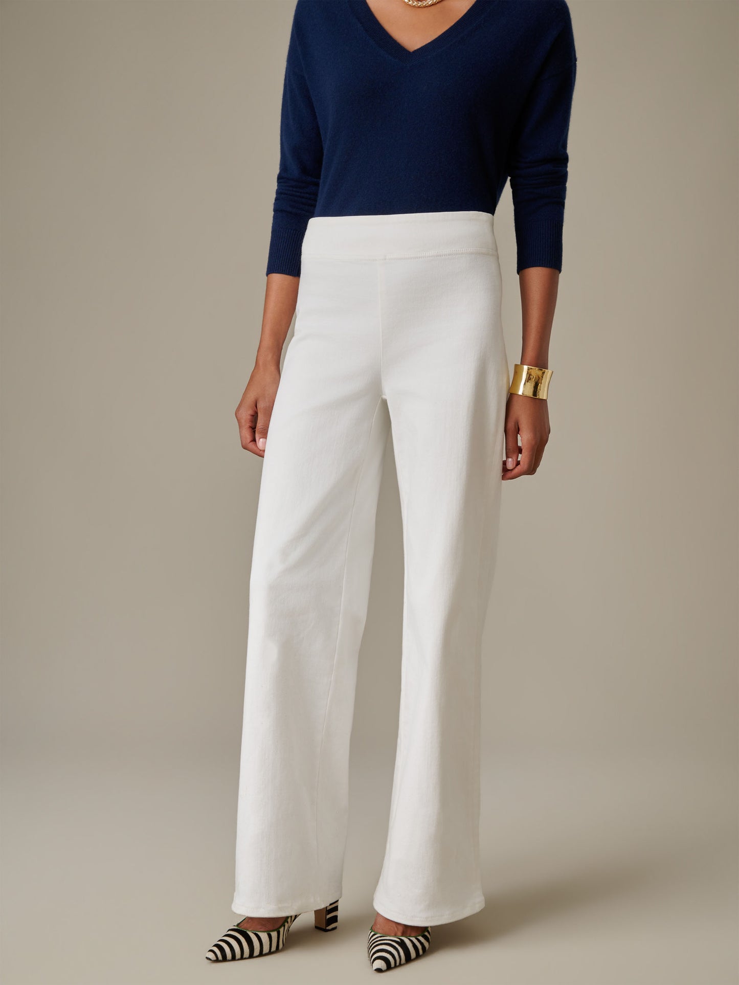 Woman wearing Anderson Jeans by J.McLaughlin, featuring a timeless silhouette paired with a navy top and striped heels, reflecting effortless style and enduring design.