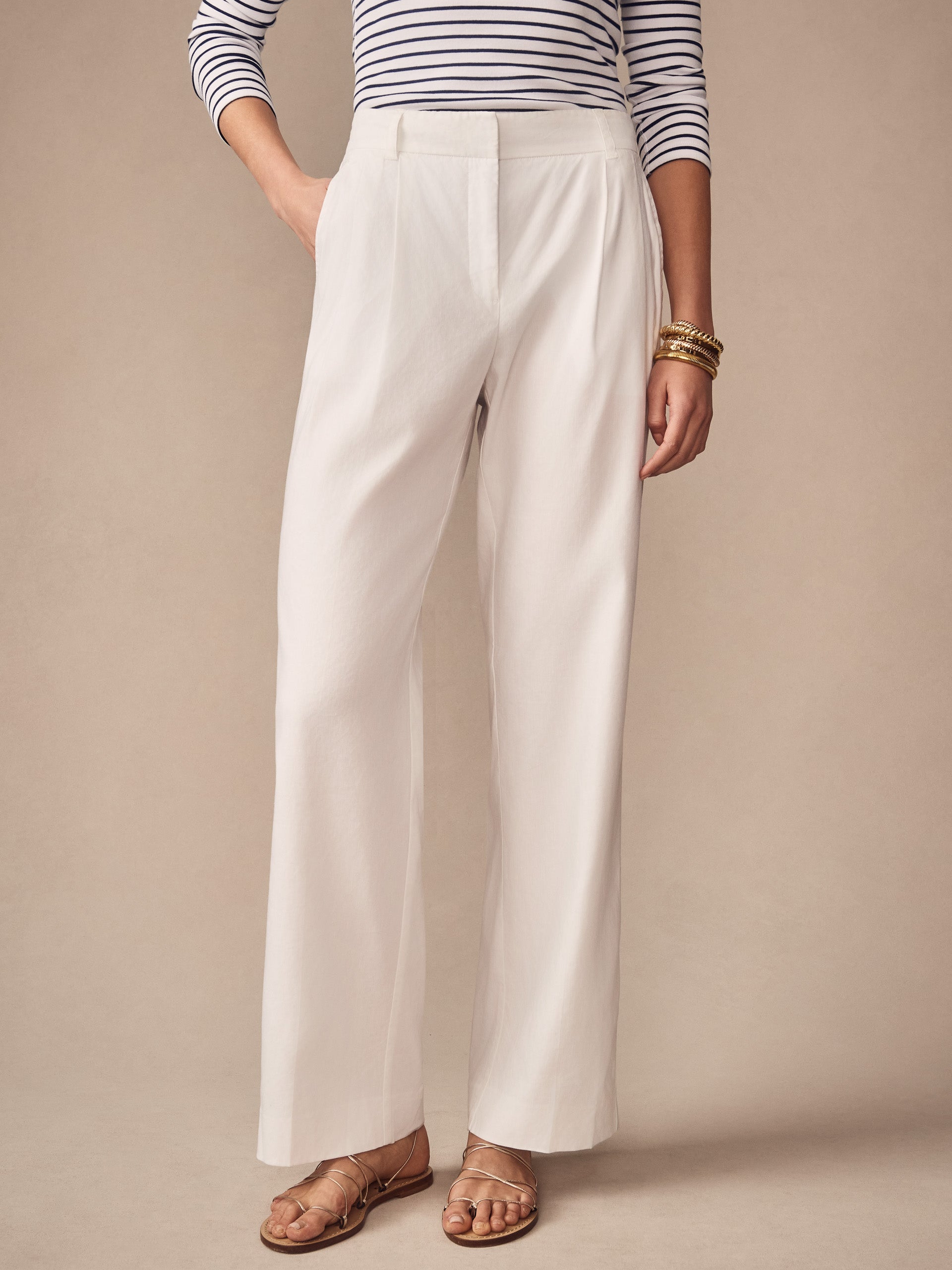 Woman wearing J.McLaughlin Fiona Linen Blend Pants in a classic cream shade paired with a striped top and gold bracelets, showcasing effortlessly stylish, enduring designs for a life well-lived.