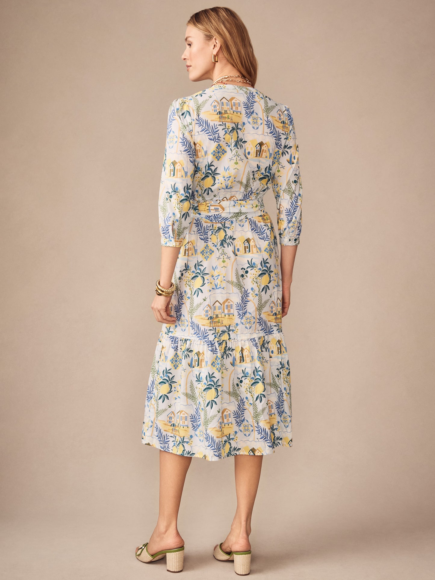Woman wearing the Cerina Dress in Amalfi Coast by J.McLaughlin featuring a light blue and yellow patterned fabric, epitomizing effortlessly stylish and enduring designs with a legacy of timeless fashion. A destination for defining style. Life, Well-Lived.