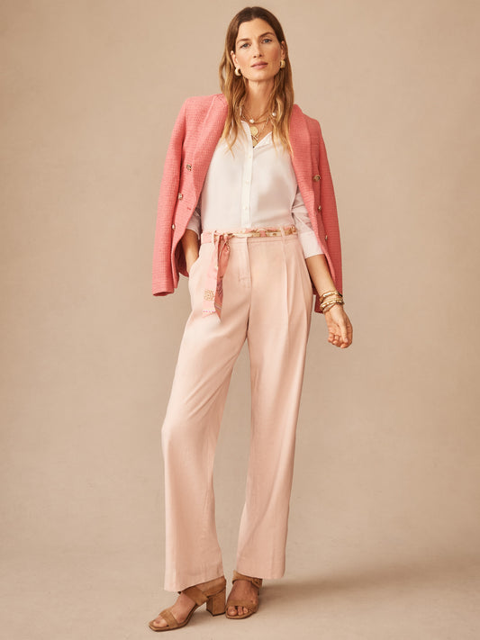 Woman wearing J.McLaughlin Fiona Linen Blend Pants styled with a white blouse and pink blazer draped over shoulders, embodying effortlessly stylish, enduring designs with innovative fabrics.