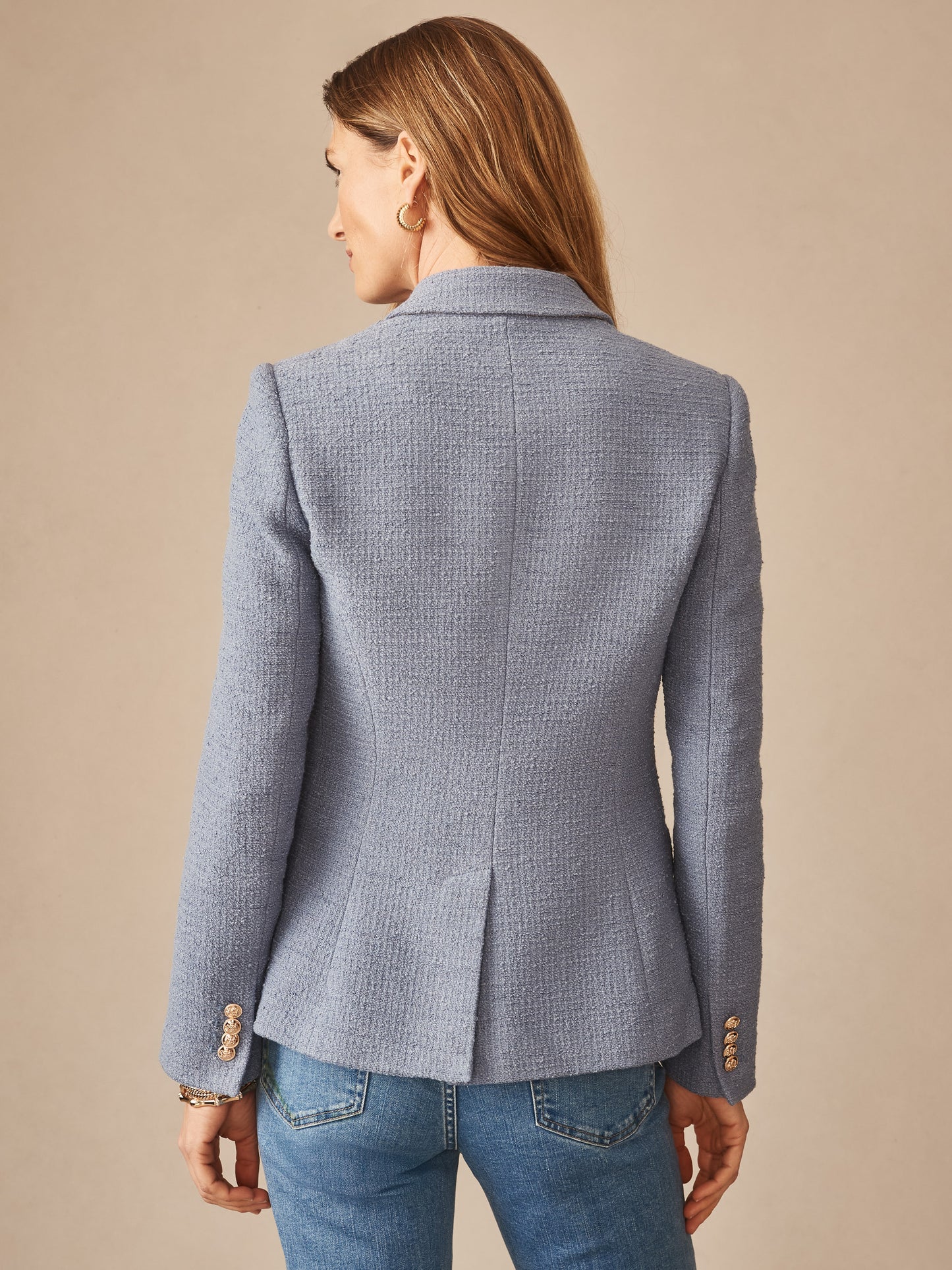 Back view of a woman wearing the Genevieve Cotton Bouclé Blazer by J.McLaughlin in a soft blue textured fabric, showcasing effortless style and enduring design from a brand known for innovative fabrics and timeless fashion.