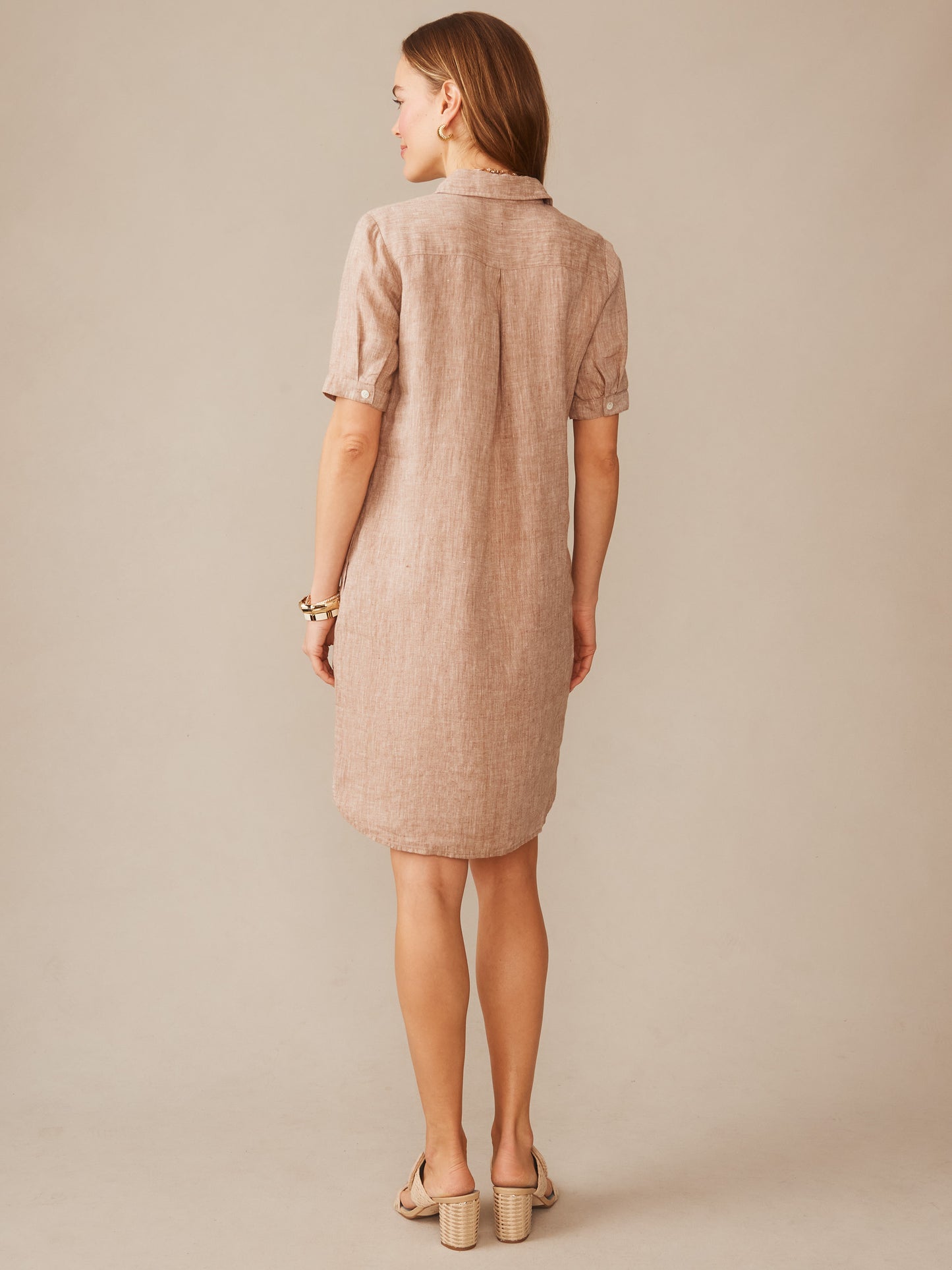 Woman wearing an effortlessly stylish Arissa Linen Dress by J.McLaughlin in a soft latte hue, showcasing enduring designs and innovative fabrics for a legacy of timeless fashion.
