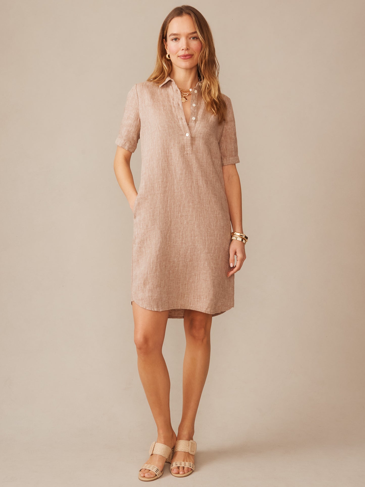 Woman wearing an effortlessly stylish Arissa Linen Dress in a soft latte shade by J.McLaughlin, showcasing enduring designs and innovative fabrics for a legacy of timeless fashion.