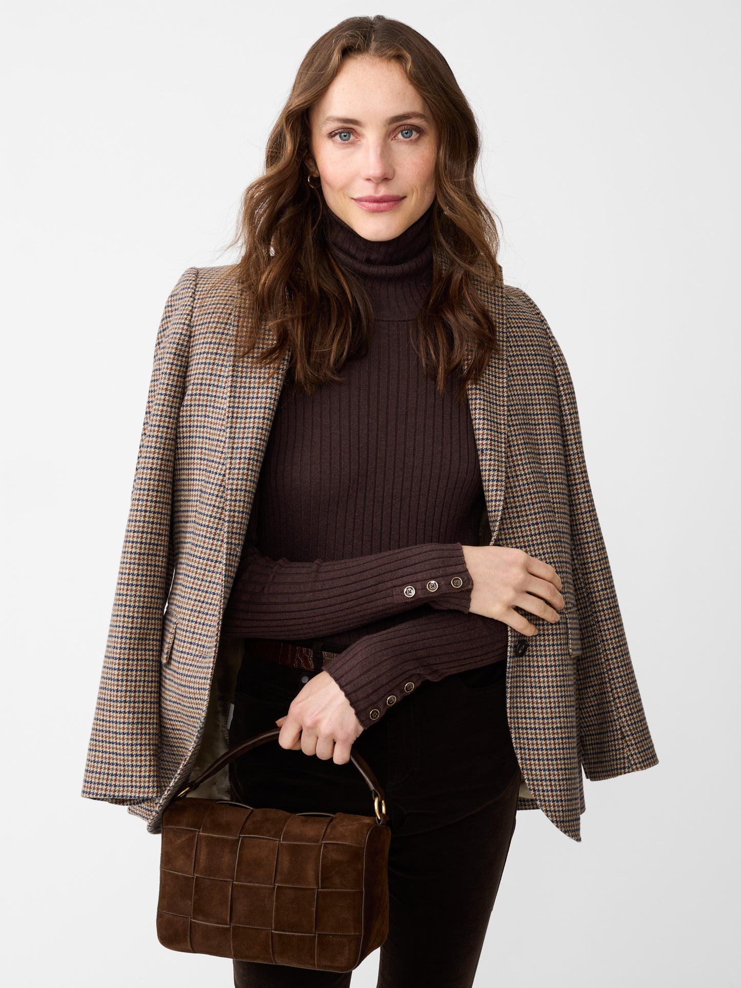 Model wearing J.McLaughlin Arlette turtleneck in heather brown made with cotton/modal.