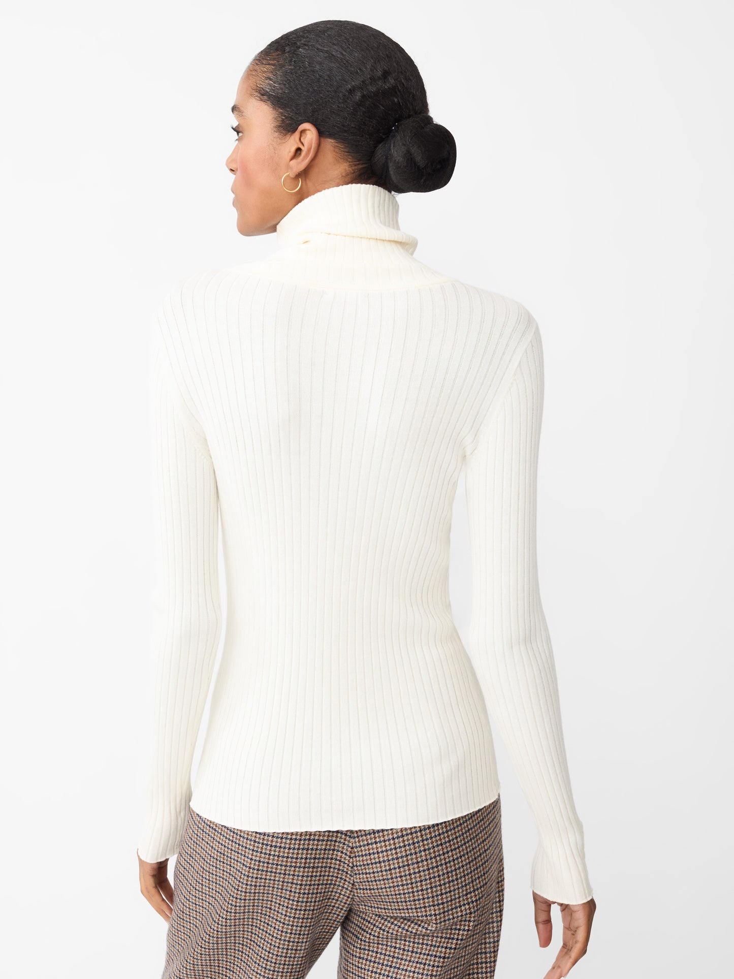 Model wearing J.McLaughlin Arlette turtleneck in egret white made with cotton/modal.