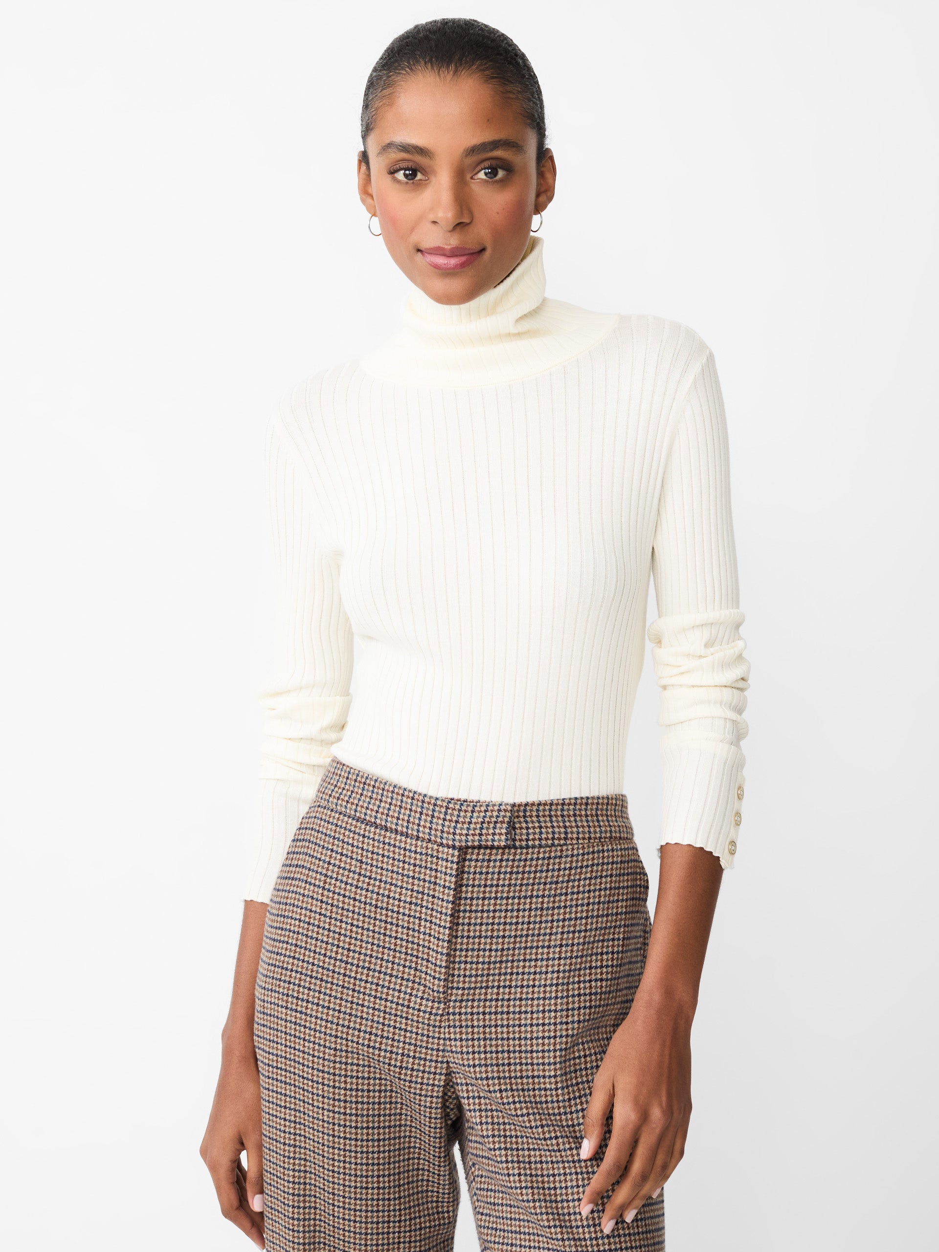 Model wearing J.McLaughlin Arlette turtleneck in egret white made with cotton/modal.