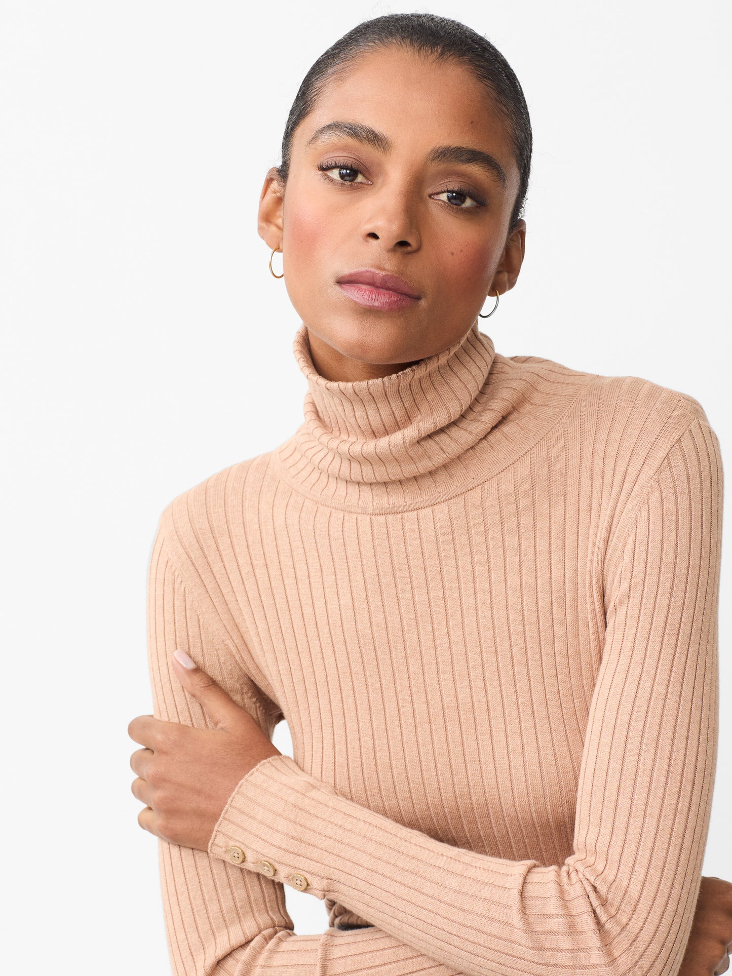 Model wearing J.McLaughlin Arlette turtleneck in heather camel made with cotton/modal.