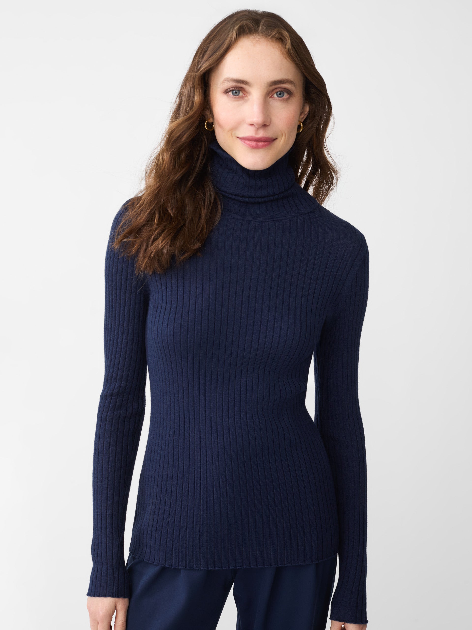 Model wearing J.McLaughlin Arlette turtleneck in navy made with cotton/modal.