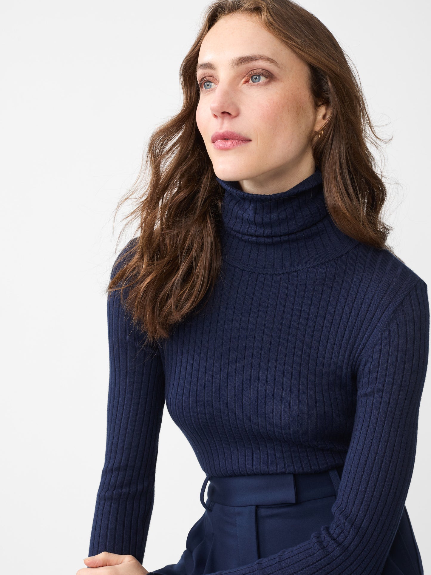 Model wearing J.McLaughlin Arlette turtleneck in navy made with cotton/modal.