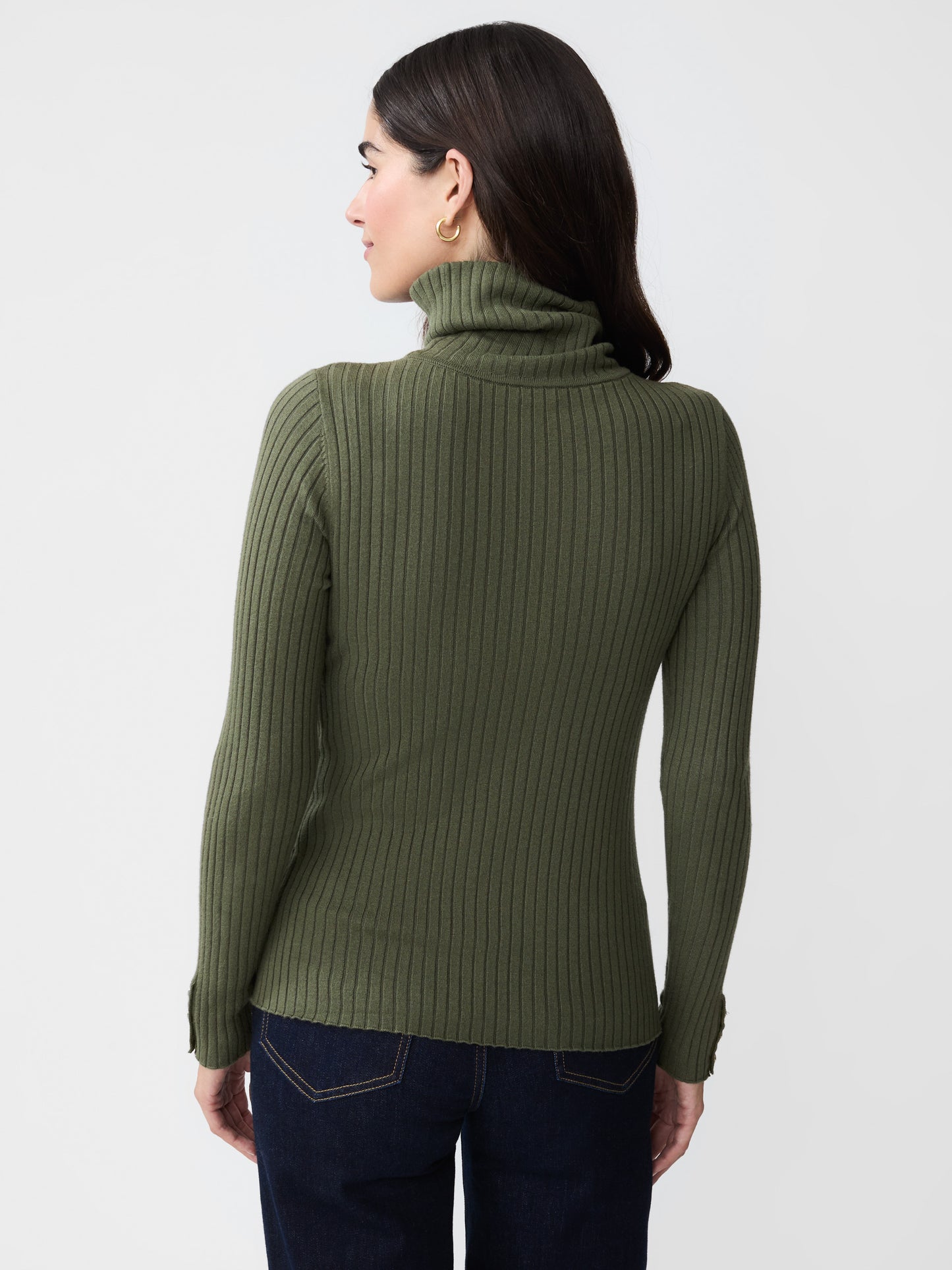 Model wearing J.McLaughlin Arlette turtleneck in olive green made with cotton/modal.