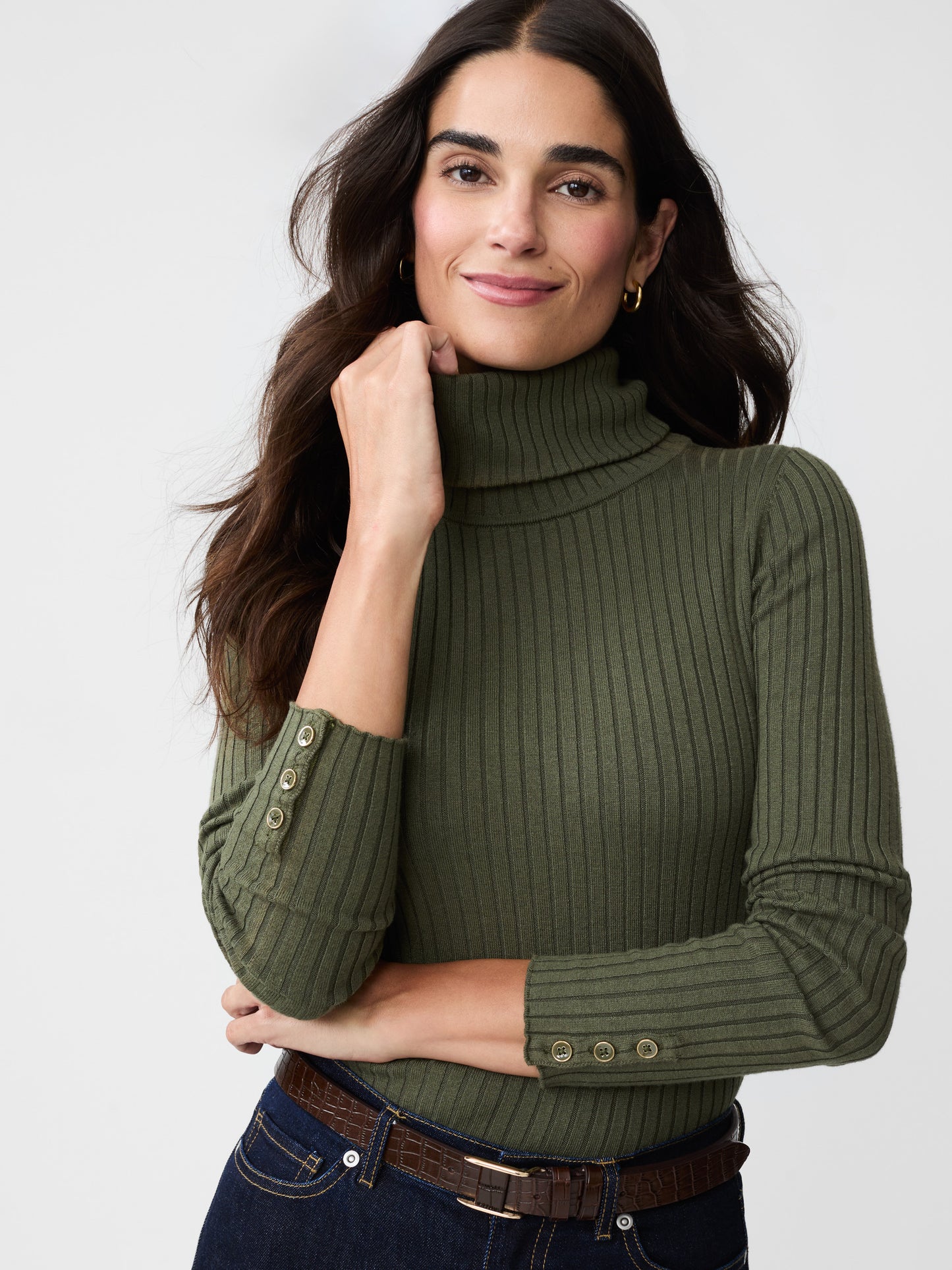 Model wearing J.McLaughlin Arlette turtleneck in olive green made with cotton/modal.