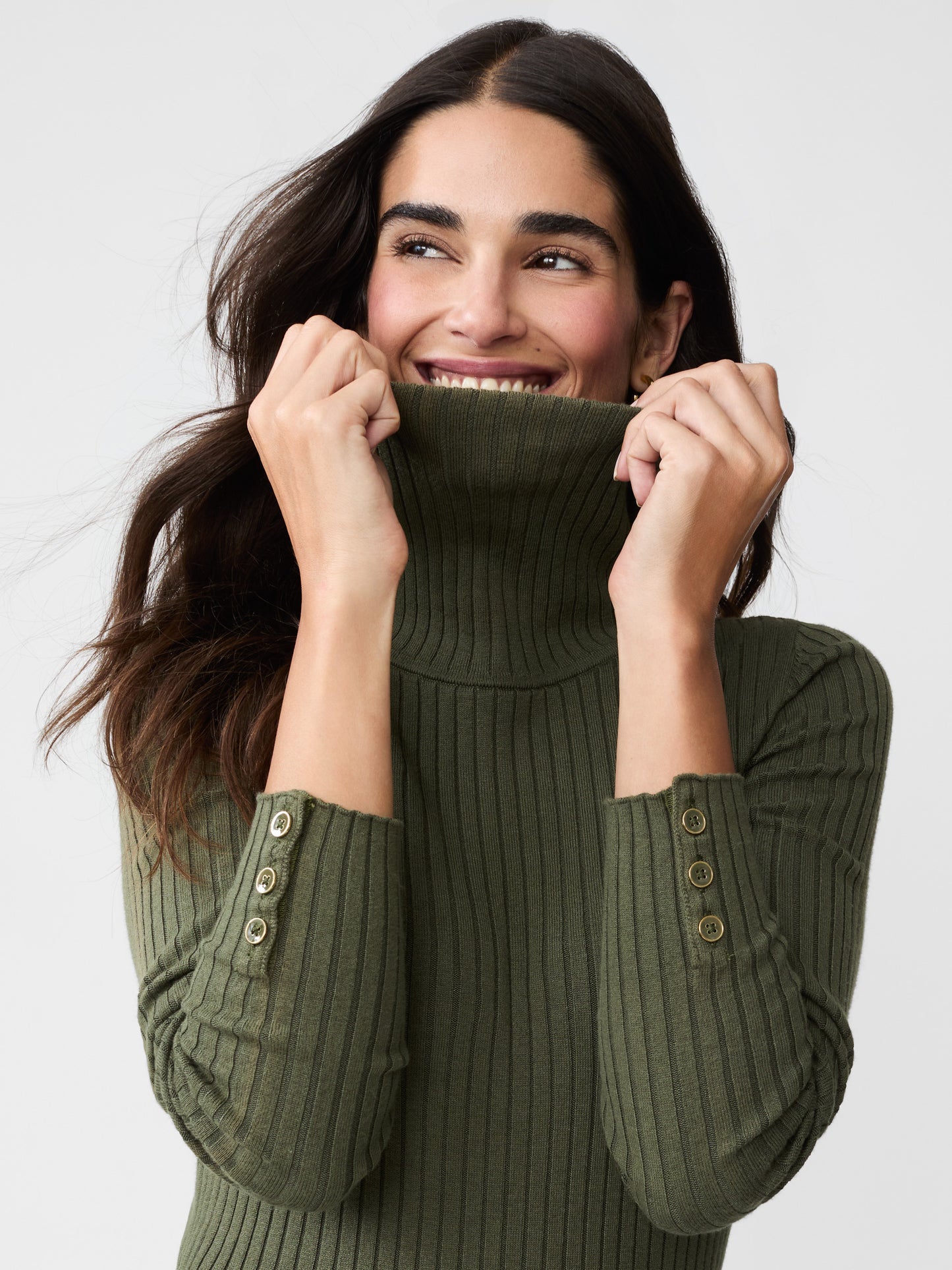 Model wearing J.McLaughlin Arlette turtleneck in olive green made with cotton/modal.