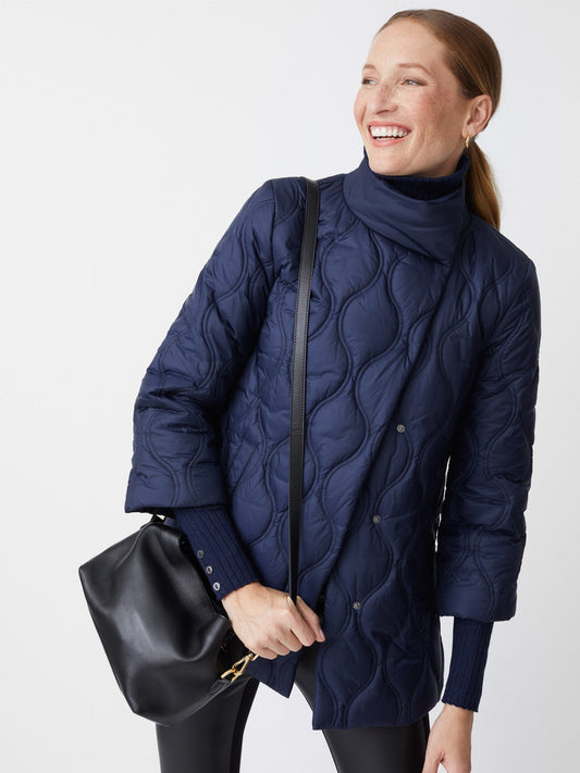Model wearing J.McLaughlin Key puffer jacket in dark navy made with polyester.