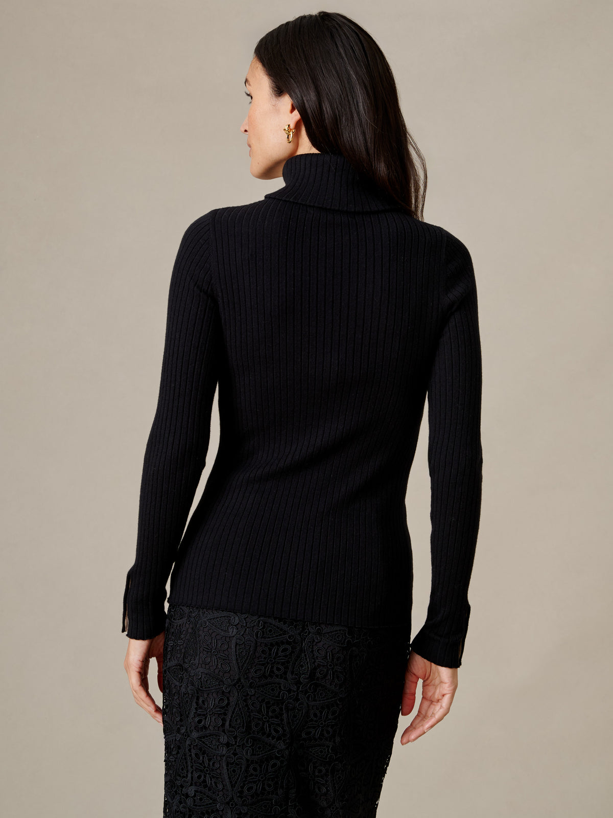 J.McLaughlin Arlette Turtleneck black ribbed top with a fitted silhouette and high neckline shown from the back on a model